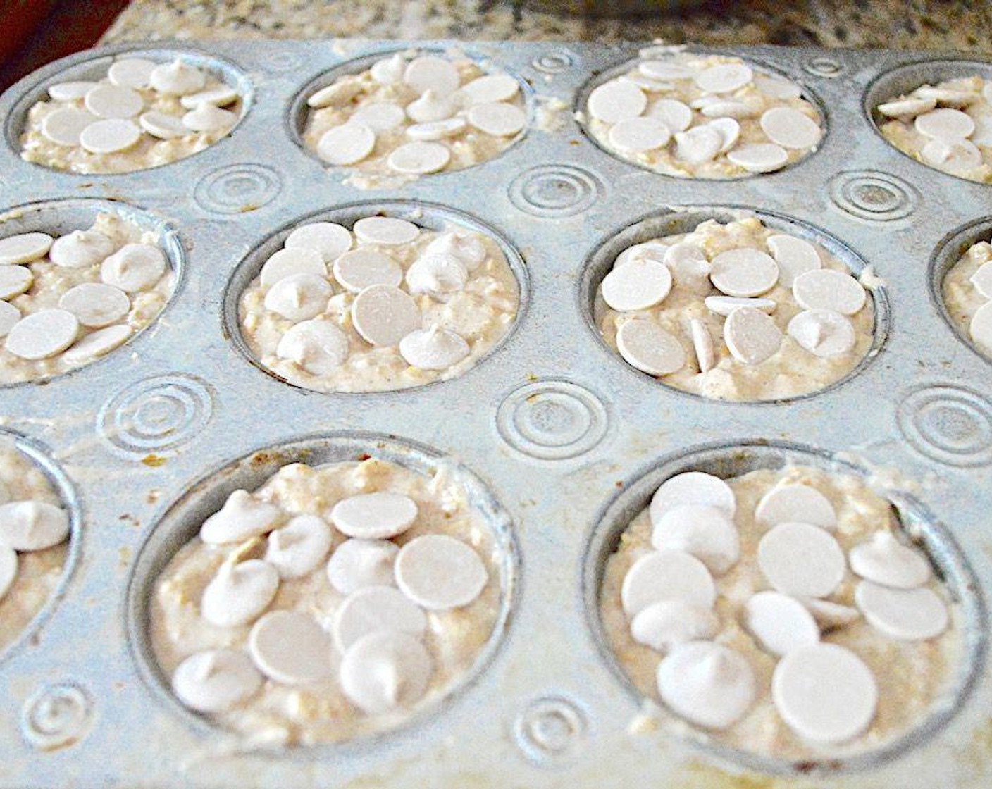 step 4 Stir in the All-Purpose Flour (2 cups) just until it disappears. Don't overwork it. Fill each muffin well pretty much to the top, then sprinkle a handful of the Vegan Caramel Chips (to taste) on top and press them into the batter so they stick.