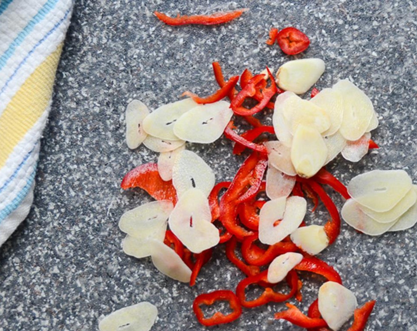 step 8 Thinly slice the Garlic (1 clove) and the Red Chili Pepper (1). Heat the remaining olive oil in the skillet and add the garlic and red chile. Cook for 2 to 3 minutes until fragrant and beginning to brown. Remove from heat and transfer the contents of the pan to the broccoli.