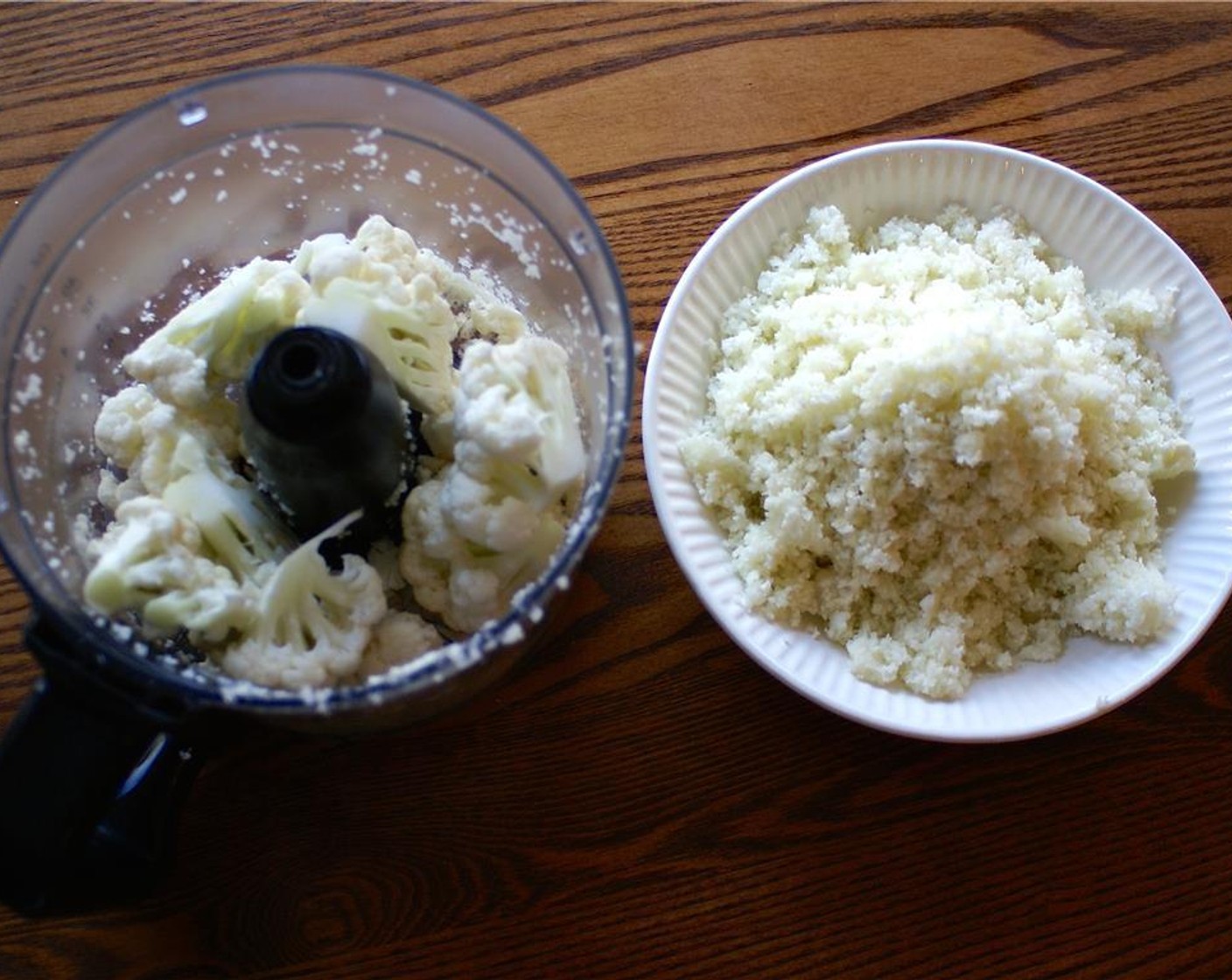 step 3 In two batches, add the cauliflower to the base of a food processor and process until a rice-like texture is achieved, about 10-12 seconds.
