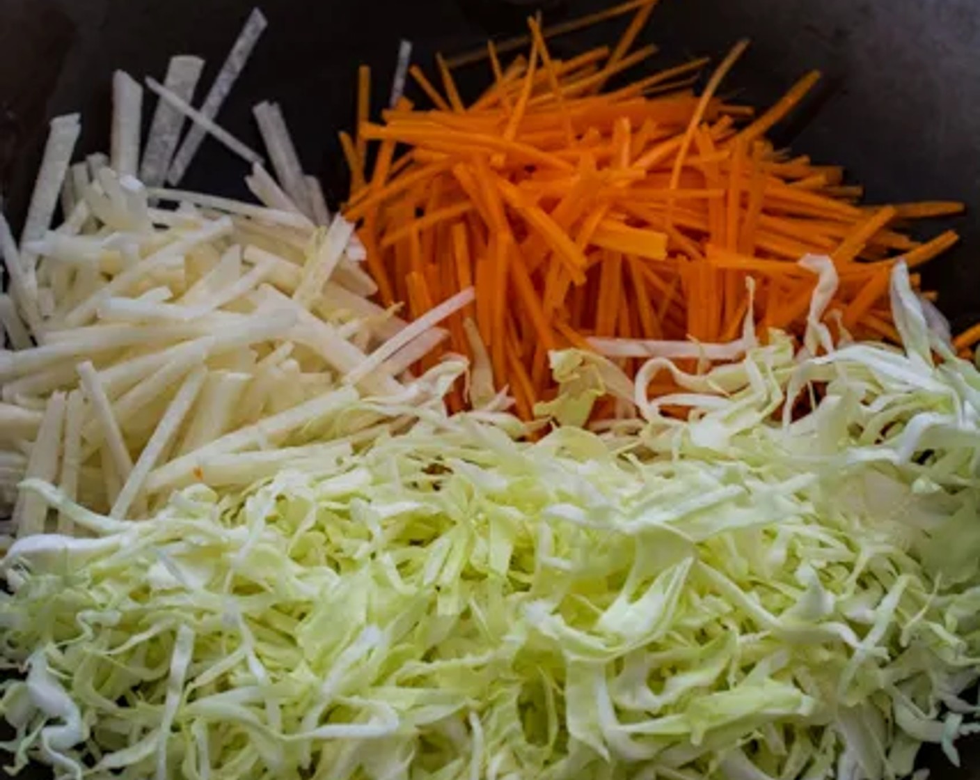 step 1 Heat Cooking Oil (2 Tbsp) in a wok over medium-high heat, then add White Cabbage (4 cups), Jicamas (2 cups), and Carrots (2 cups) to the wok. Stir-fry the vegetables until they turn soft.