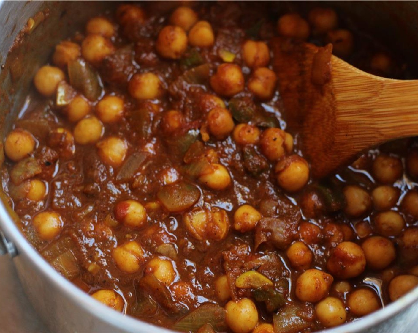 step 6 Once the tomato has reduced and the ghee starts to separate from the sauce, add the Canned Chickpeas (2 1/2 cups) and Water (1/2 cup). Mix, then bring to a boil before reducing to a simmer.