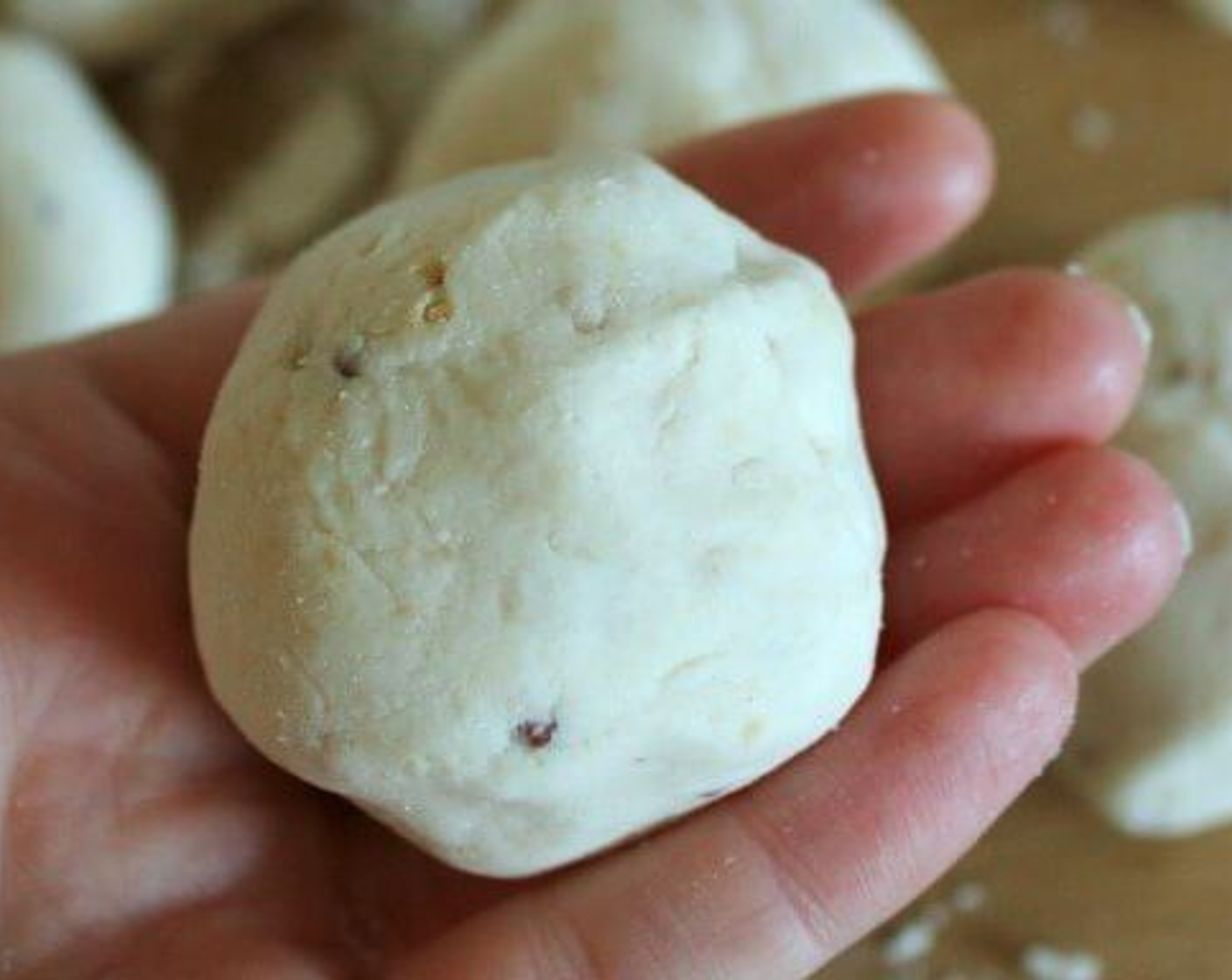 step 4 Now divide the dough in half, then each half into 5 equal pieces and roll them into balls. On the floured surface, roll the dough balls out with a floured rolling pin until they are about 3-mm thick and 10-cm round.