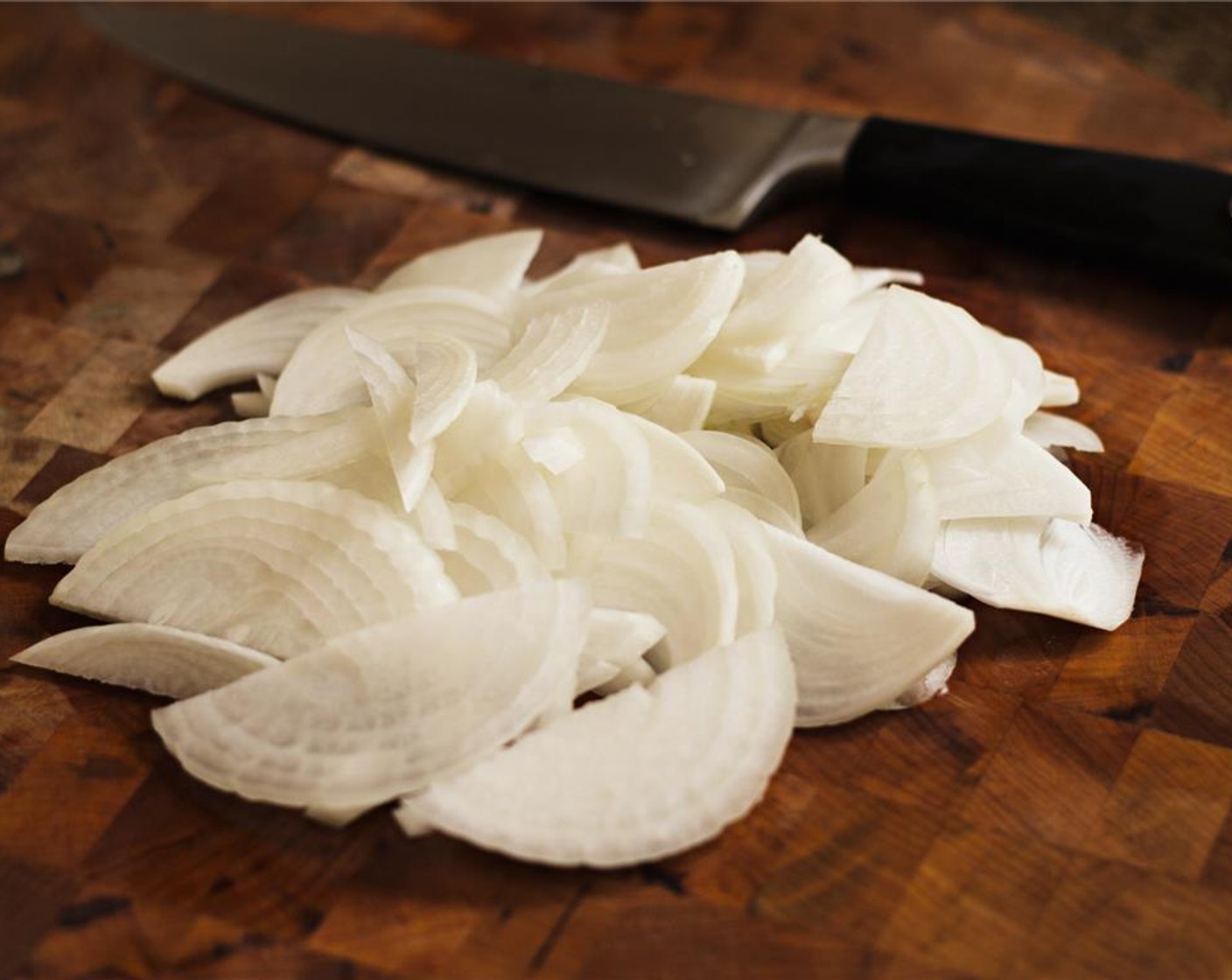 step 6 Slice the Sweet Onion (1) in half, then slice into thin pieces.