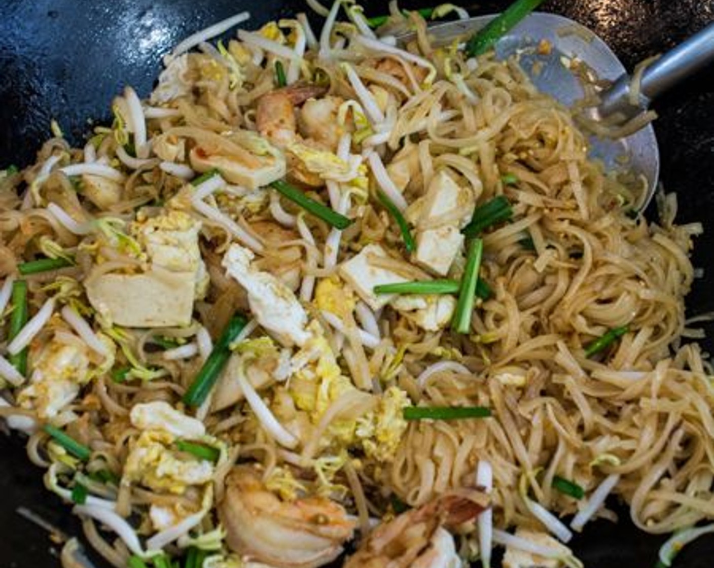 step 10 Return the cooked shrimp and eggs to the wok. Add Bean Sprouts (1 cup), Firm Tofu (2 Tbsp), Chinese Chives (2 Tbsp), Dried Shrimp (2 Tbsp) and Dry Roasted Peanuts (2 Tbsp)