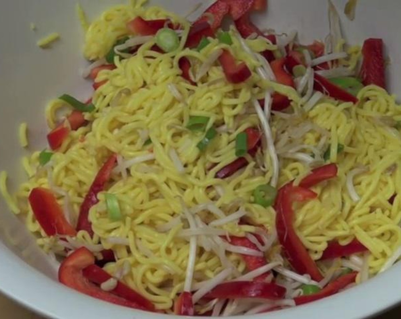 step 2 In a big salad bowl, toss together the cooled Noodles (1 pckg), Scallion (1 bunch), Bean Sprouts (1 handful), and Red Bell Pepper (1).