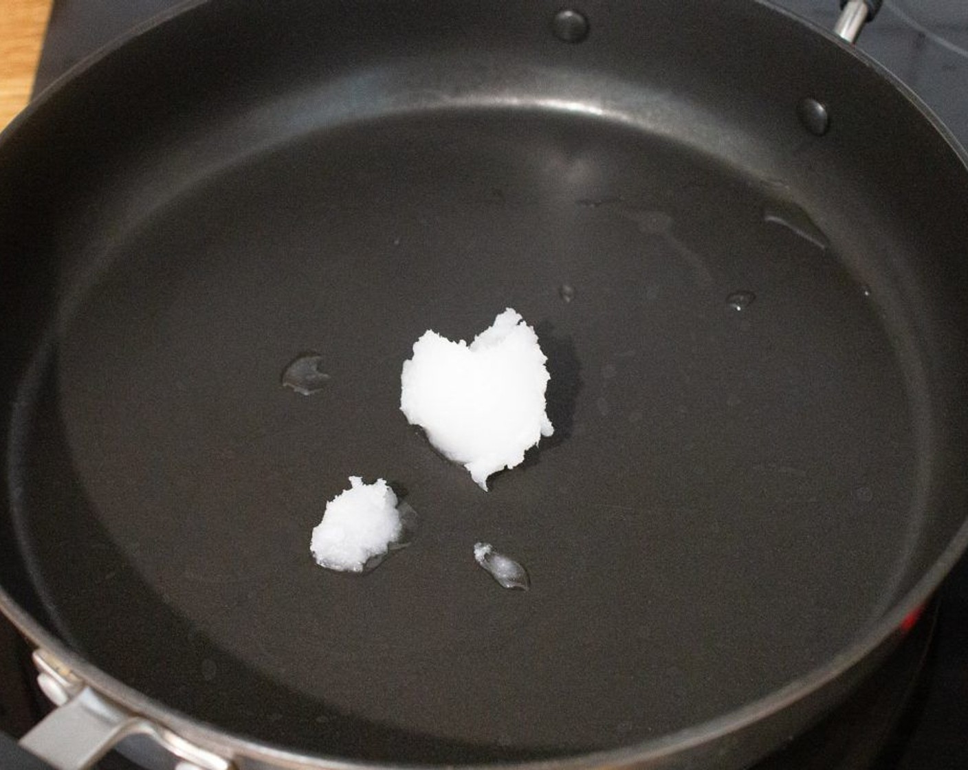 step 2 Heat the Coconut Oil (1 Tbsp) in a large, non-stick frying pan over medium heat until it has melted.
