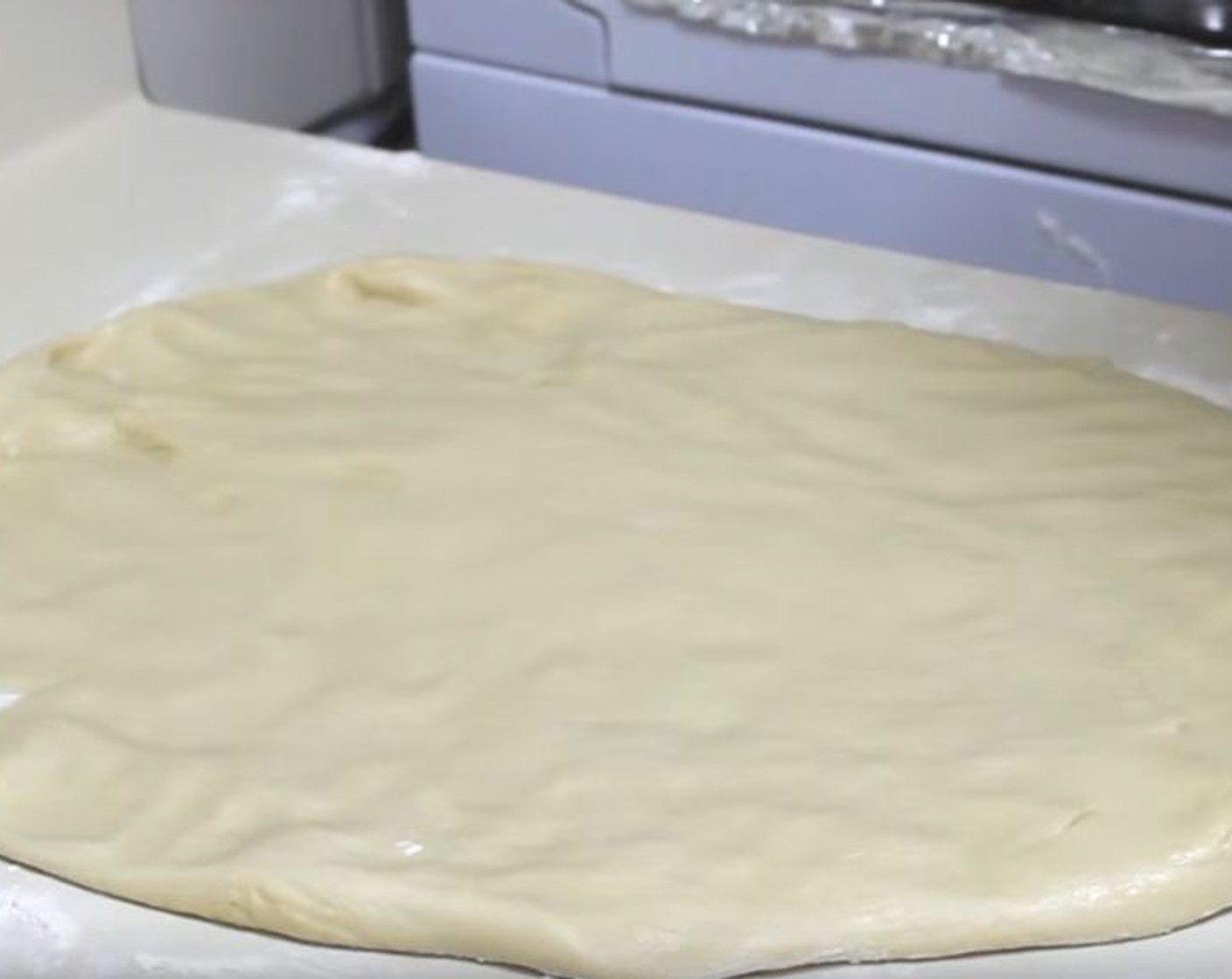 step 6 After about one hour, put the dough onto a floured surface, and using a rolling pin form the dough into a rectangular shape.