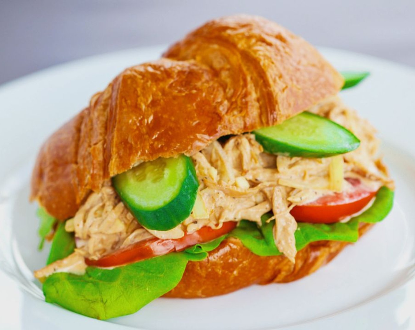 step 7 To make the croissandwich, toast the Croissants (4) in an oven or toaster for a few minutes if desired. Once toasted, slice in half, side down and horizontally, using a sharp knife. Layer Butter Lettuce (to taste), spoonfuls of Spicy Asian-Cajun Chicken Salad, Tomatoes (to taste) and Cucumbers (to taste) on the bottom half of the croissant. Close with the top half and enjoy!