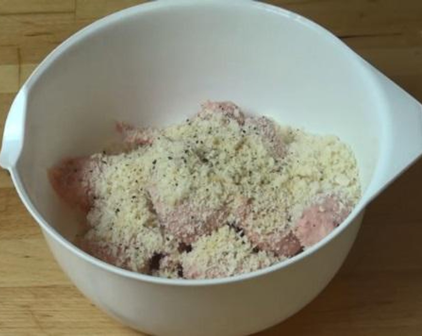 step 1 Into a bowl, squeeze the meat out of each Pork Sausages (6). To that, add the Breadcrumbs (1/2 cup), Simply Organic Garlic Powder (1 tsp), Salt (to taste), and Ground Black Pepper (to taste). Mix together with your hands.