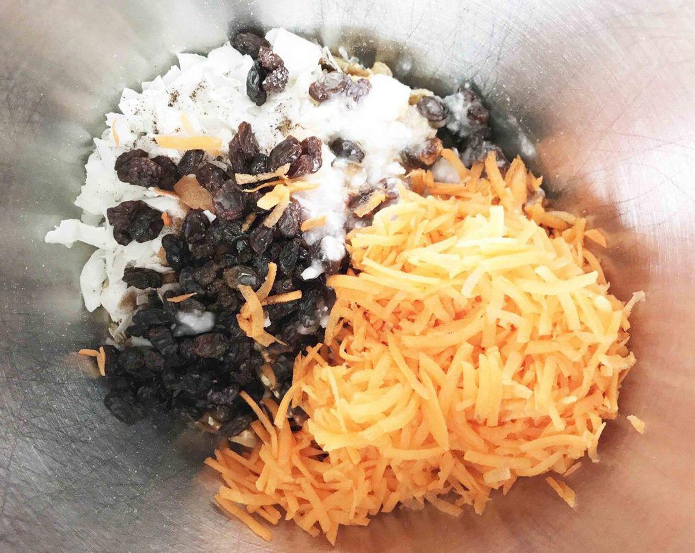 step 3 In a large bowl, mix together Old Fashioned Rolled Oats (2 cups), shredded carrot, Unsalted Raw Pecans (1 cup), Raw Walnuts (1 cup), Unsweetened Coconut Flakes (1/2 cup), Sun-Maid Raisins (1/2 cup), Maple Syrup (4 Tbsp), Coconut Oil (4 Tbsp), Simply Organic Cinnamon, Ground (1 tsp), Salt (1/2 tsp), Ground Ginger (1/4 tsp), Chia Seeds (1/4 tsp), Ground Nutmeg (1/8 tsp), and Ground Cloves (1 pinch)