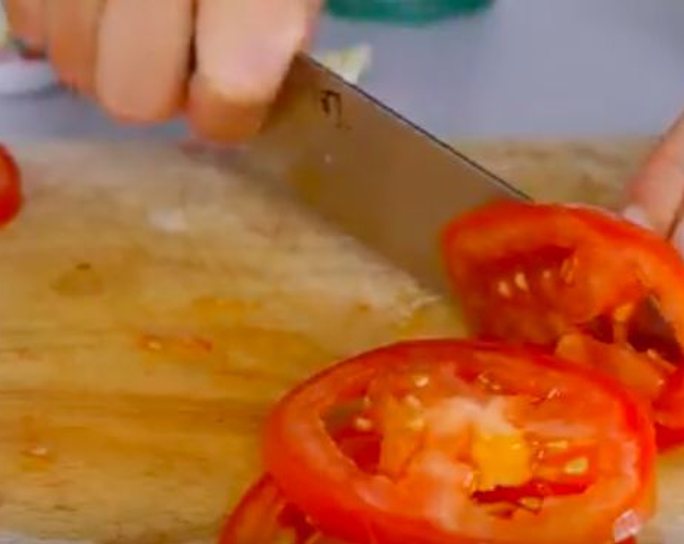 step 3 The next thing is to prep the veggies by slicing the Onion (1) into thin-ish slices. Then the Tomato (1) in approx. 0.5cm slices. You might find it easier to slice the tomato using a serrated knife. Then leave aside to use later. Slice the Scallion (1 stalk), if using.