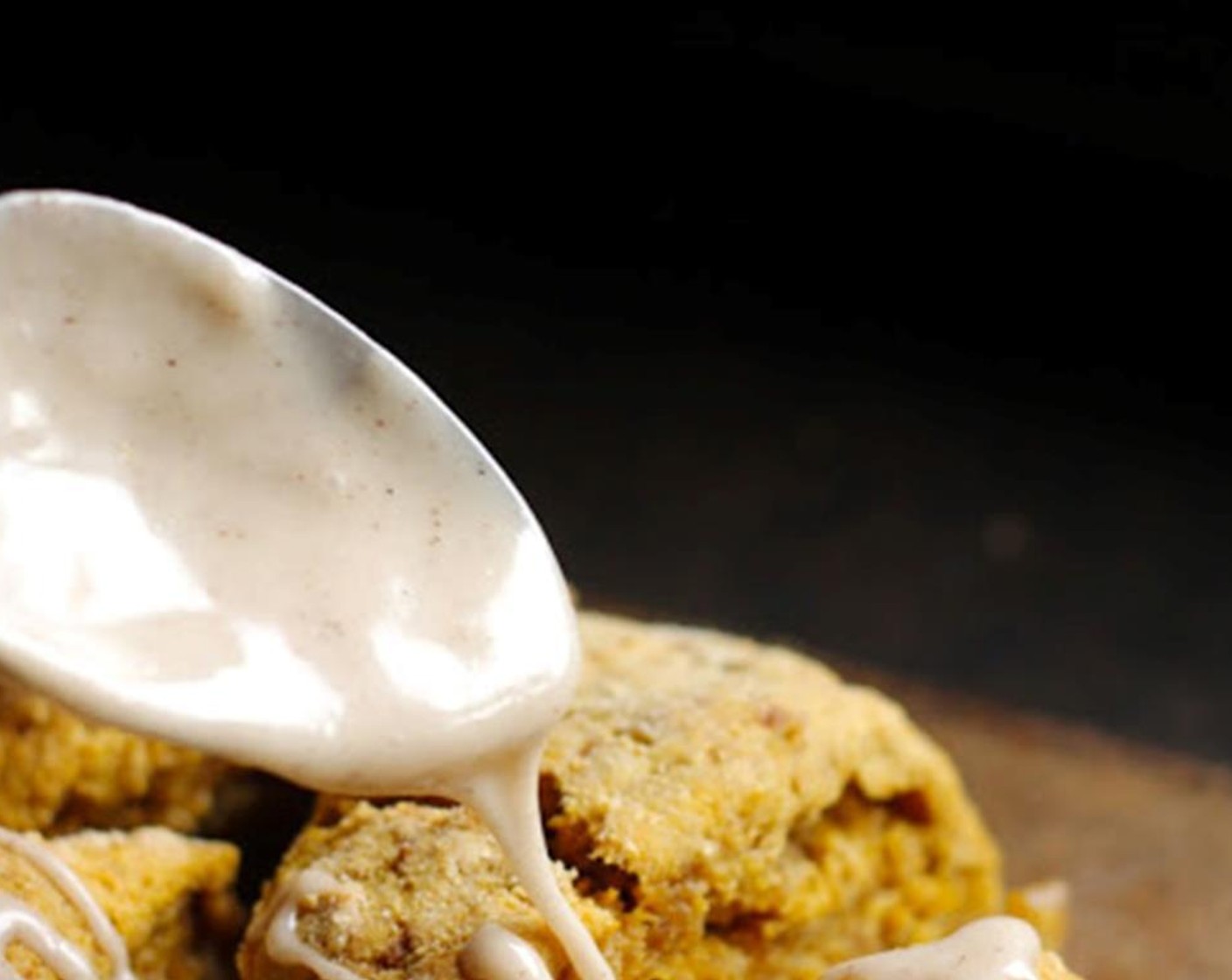 step 7 To make the icing, combine the Powdered Confectioners Sugar (135 g), Cream (2 Tbsp), Ground Cinnamon (1 tsp), Cinnamon Essential Oil (1 drop), and Vanilla Extract (1 tsp). Whisk until smooth. When the scones are done, cool for 10 minutes. Drizzle each scone with icing.