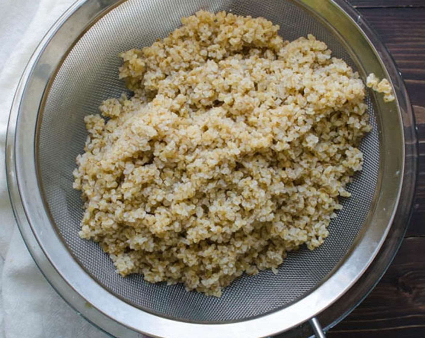 step 6 Remove the plastic wrap from the bulgur wheat and fluff with a fork. If there is liquid left in the bottom of the bowl, strain it out.