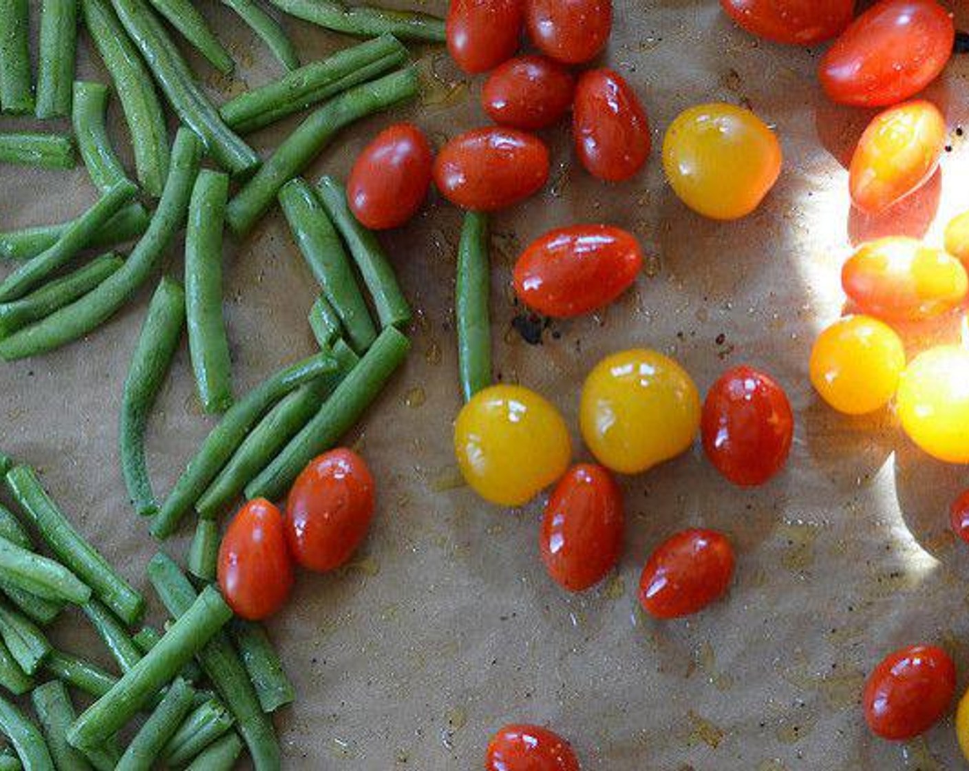 step 2 Evenly spread out Green Beans (2 cups) and Cherry Tomatoes (2 cups) on a baking sheet. Drizzle with Olive Oil (1 Tbsp) and toss to coat vegetables. Sprinkle with Salt (to taste) and Ground Black Pepper (to taste).