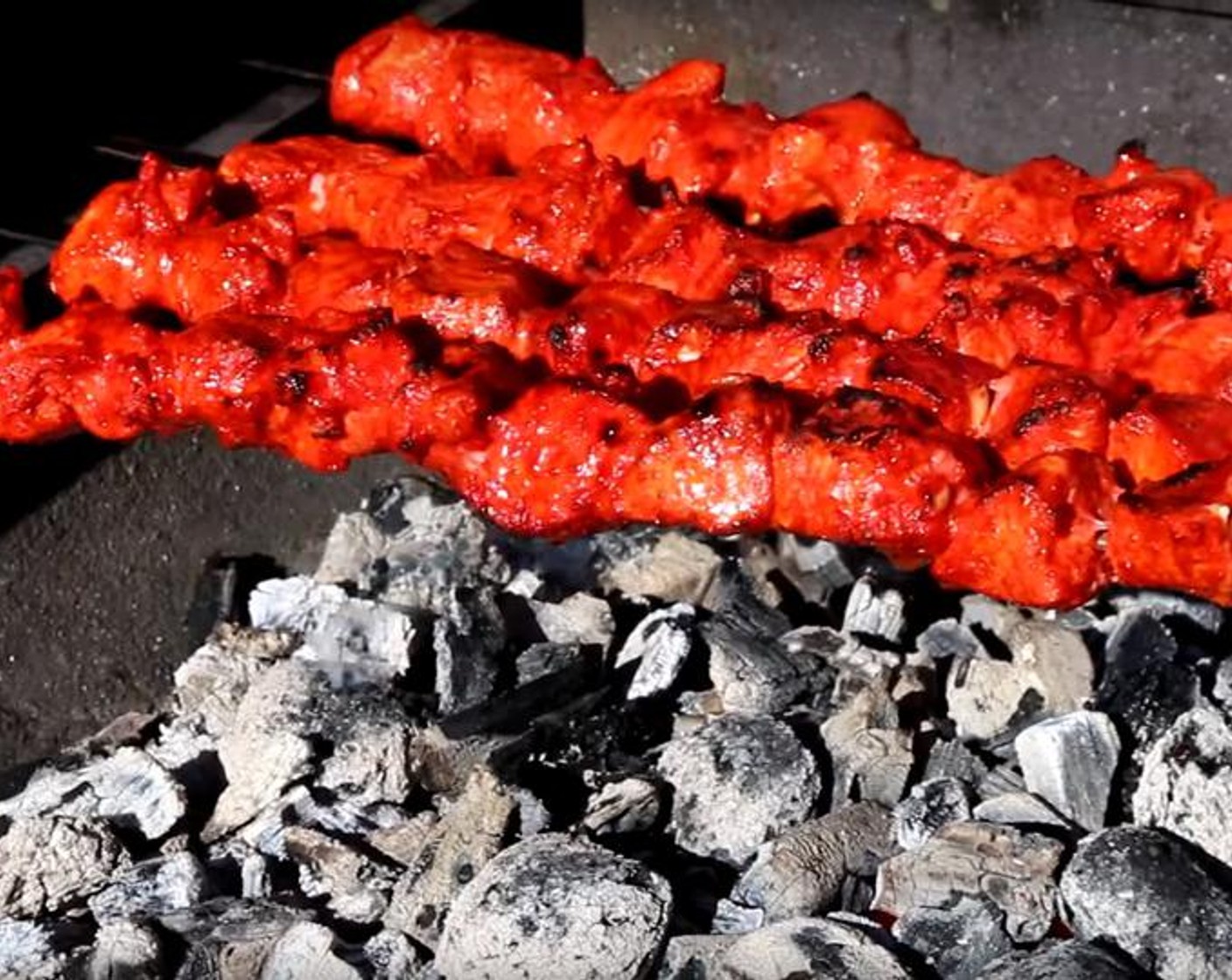 step 6 Place the skewers on the working grill. Occasionally rotate them to let the chicken cook from all sides. The time will vary based on the size of the chicken pieces and the heat of the grill, but you want the center cooked and the edges starting to char slightly.