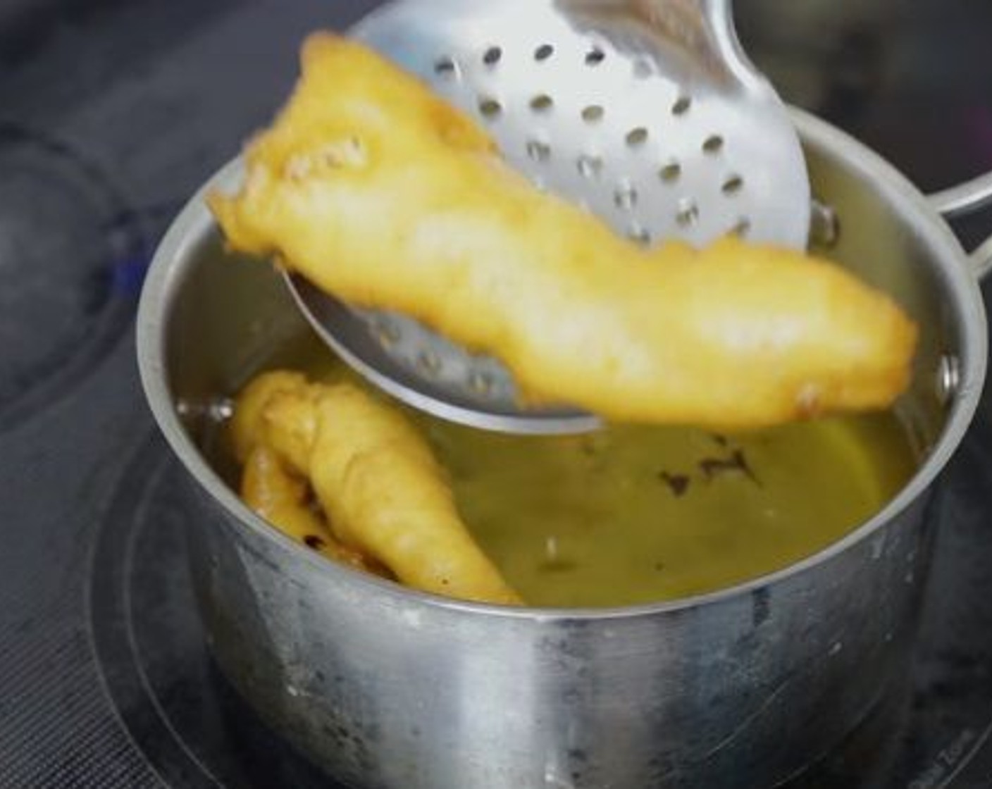 step 7 Working in small batches, dip the fish strips into batter and fry until crispy and golden brown on both sides.