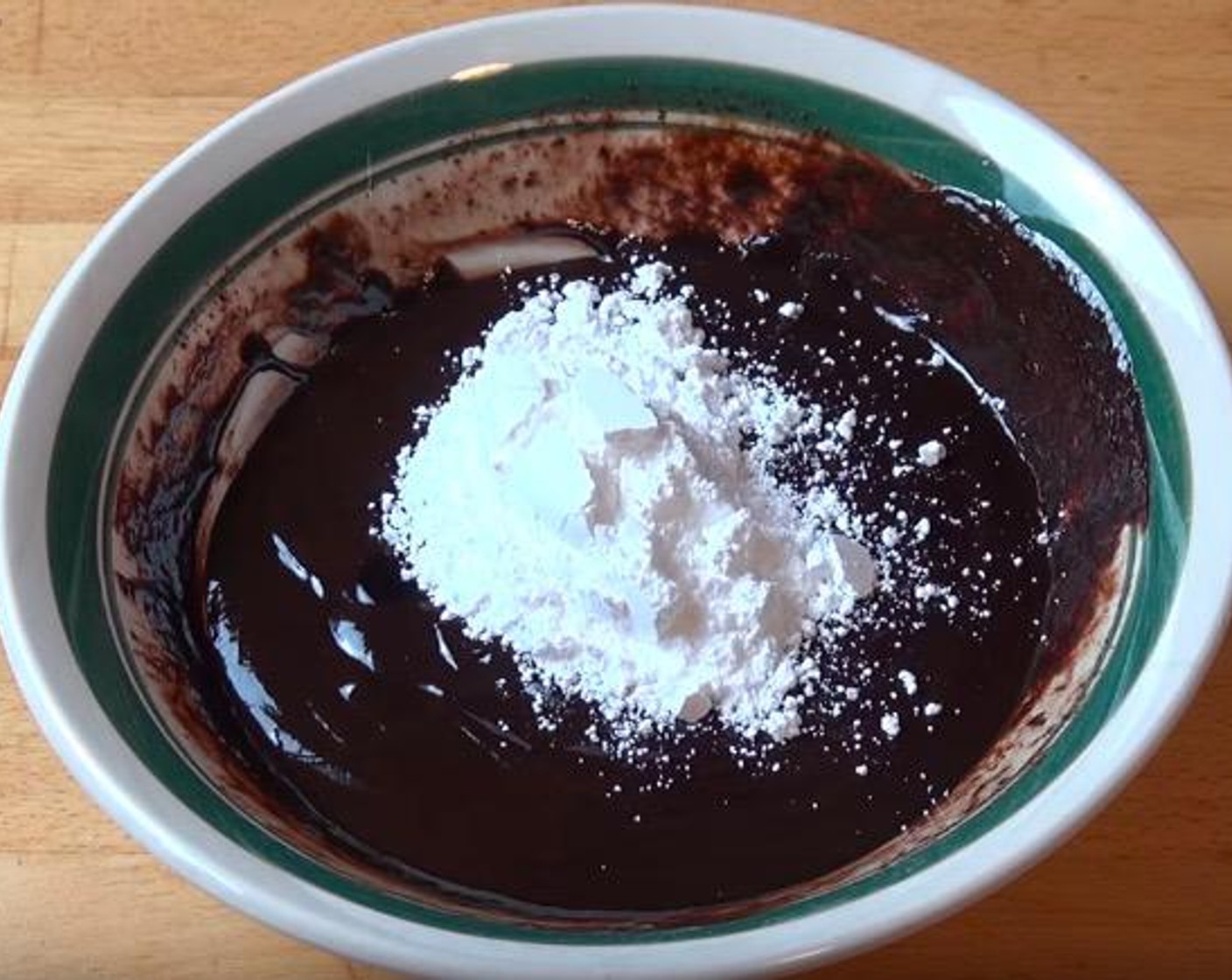 step 4 Into the chocolate and cream mixture, add Vanilla Extract (1 tsp) and Powdered Confectioners Sugar (1/4 cup). Stir until combined.