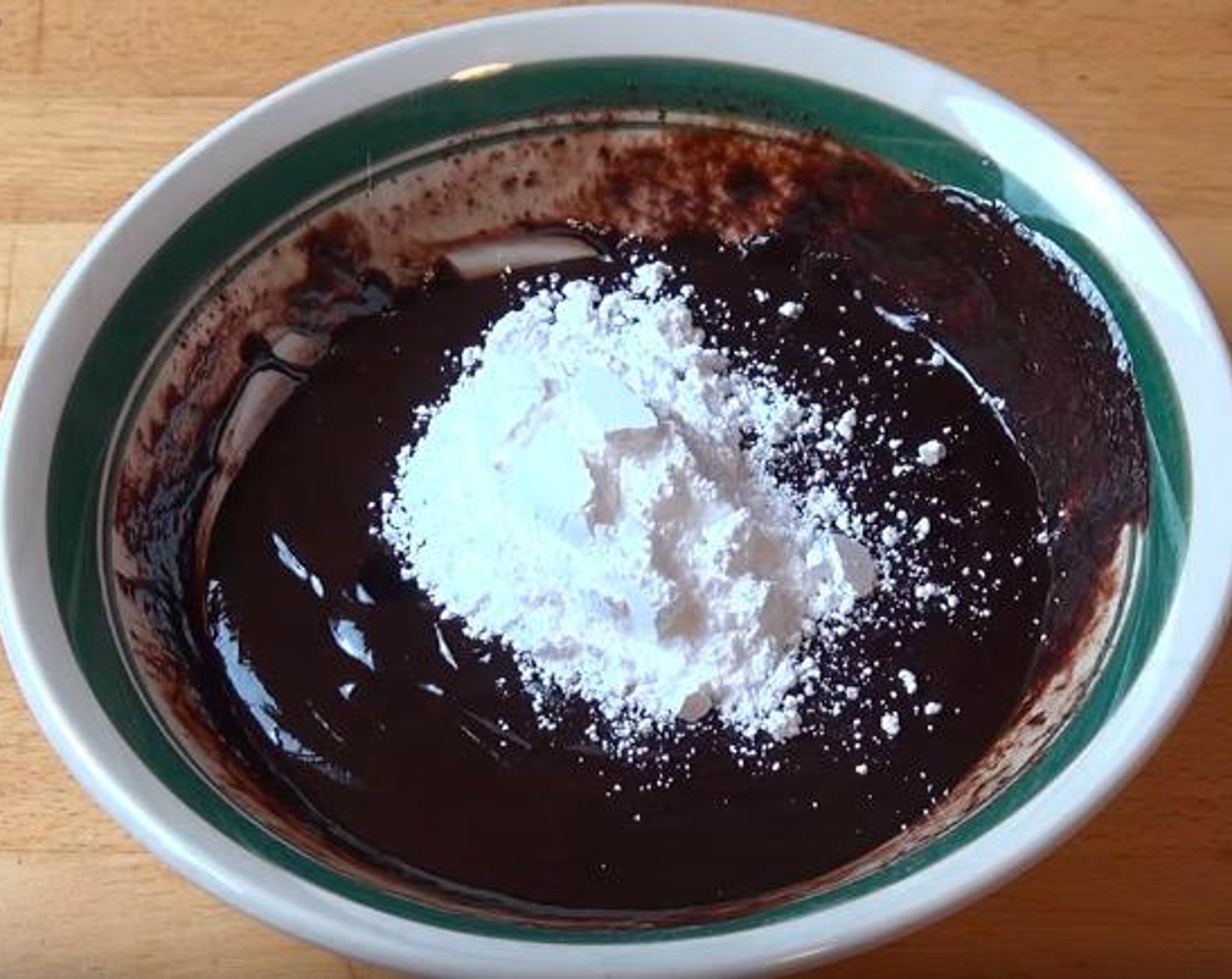 step 4 Into the chocolate and cream mixture, add Vanilla Extract (1 tsp) and Powdered Confectioners Sugar (4 Tbsp). Stir until combined.