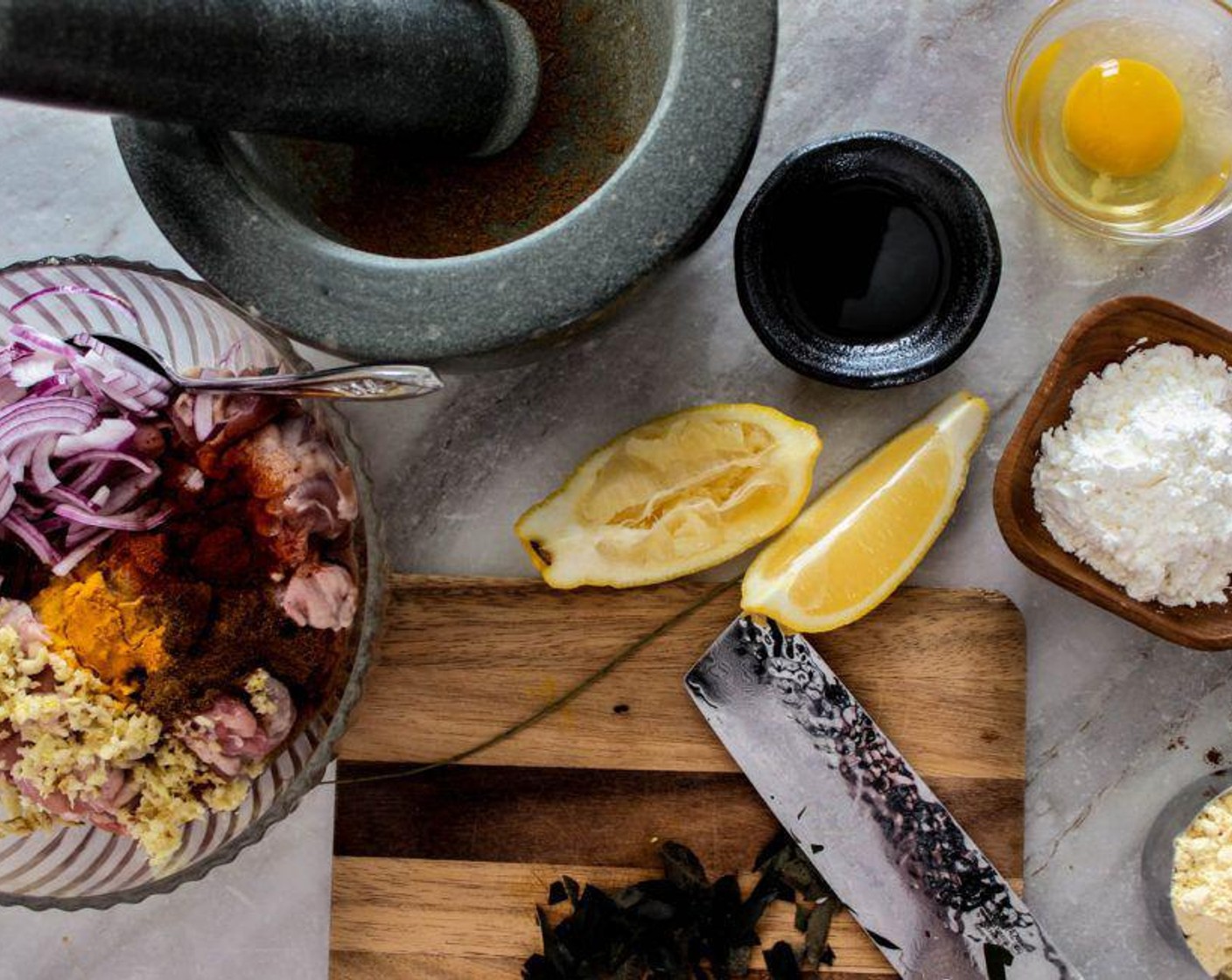 step 2 Add in the Onion (1),  Ground Cumin (1/2 Tbsp), Garam Masala (1 tsp), Ground Turmeric (1/2 tsp), Curry Leaves (20), Chili Powder (1 Tbsp), Garlic (4 cloves), and Fresh Ginger (1 Tbsp) to the bowl.