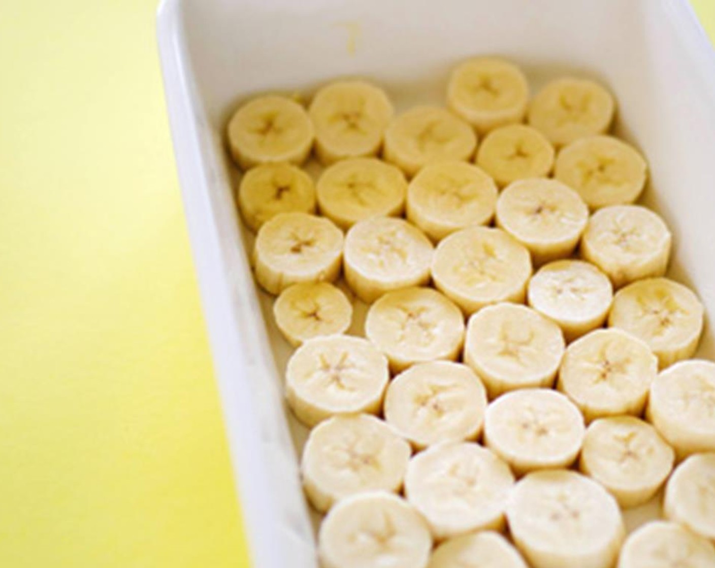 step 1 Grease a 9x13 inch baking dish and place Bananas (3) in the bottom of the pan.