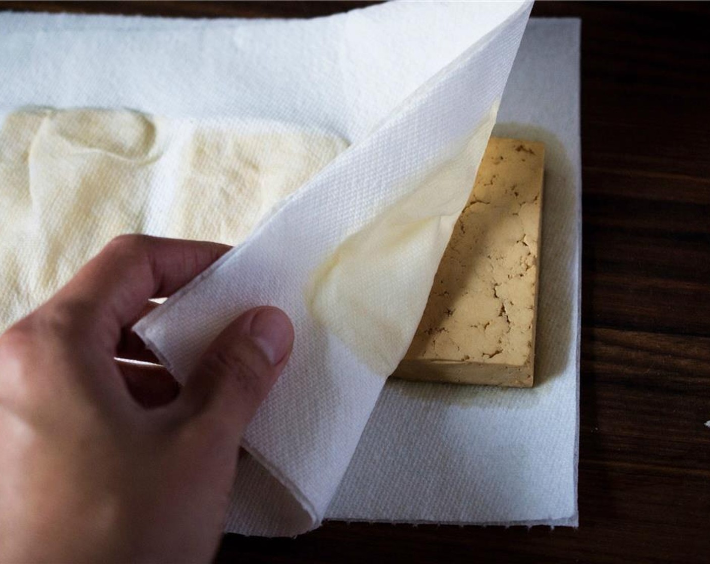 step 4 Remove the tofu from the marinade and remove the excess moisture by pressing each piece firmly between several paper towels.