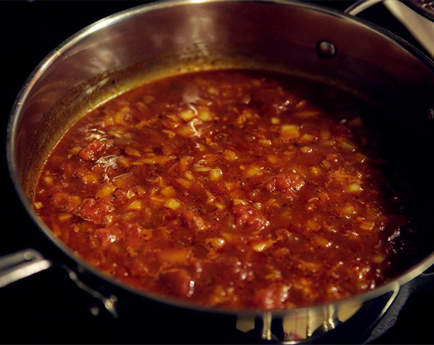 step 8 Add the Madras Curry Powder (1 Tbsp) and Hot Paprika (1 tsp), and stir to fully coat the onions. Add the Tomatoes (1 1/4 cups), Raw Sugar (3 2/3 Tbsp), and Apple Cider Vinegar (1 Tbsp). Bring to a boil, then reduce to a simmer.