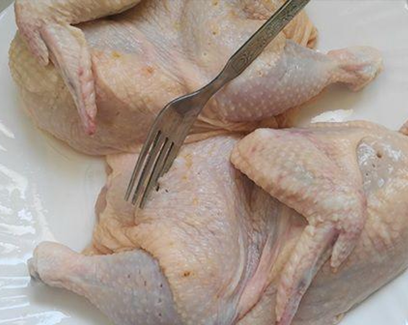 step 1 Clean and wash Whole Chickens (2.2 lb). Cut it into two pieces lengthwise, or into four pieces. Using a fork or knife prick the chicken well so that the marination goes inside the chicken.
