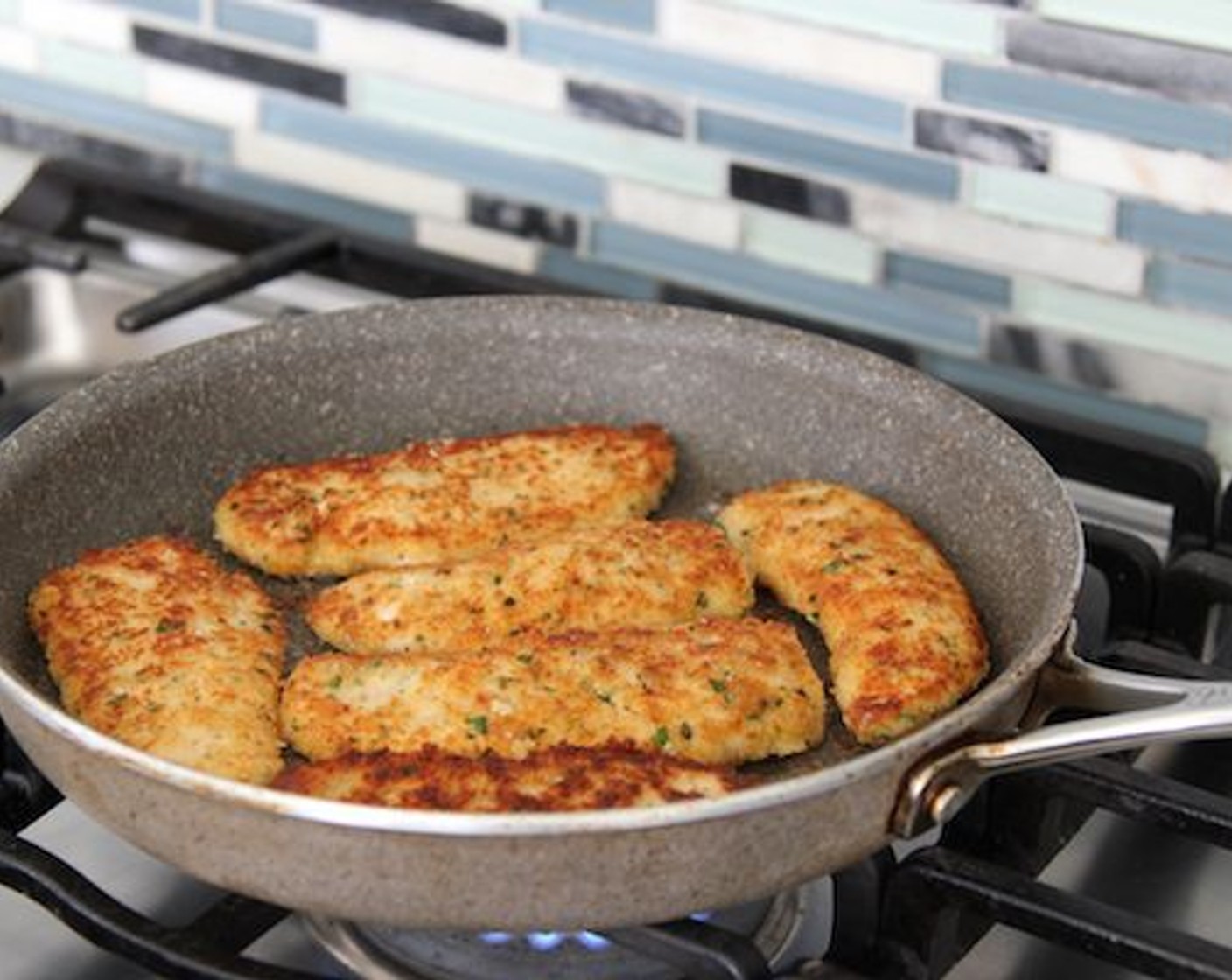 step 8 Heat 1 1/2 – 2 Tablespoons of oil in a large skillet and heat over medium-high heat until shimmering. Add the chicken tenders and cook until the chicken is golden brown on both sides, about 2-4 minutes per side.