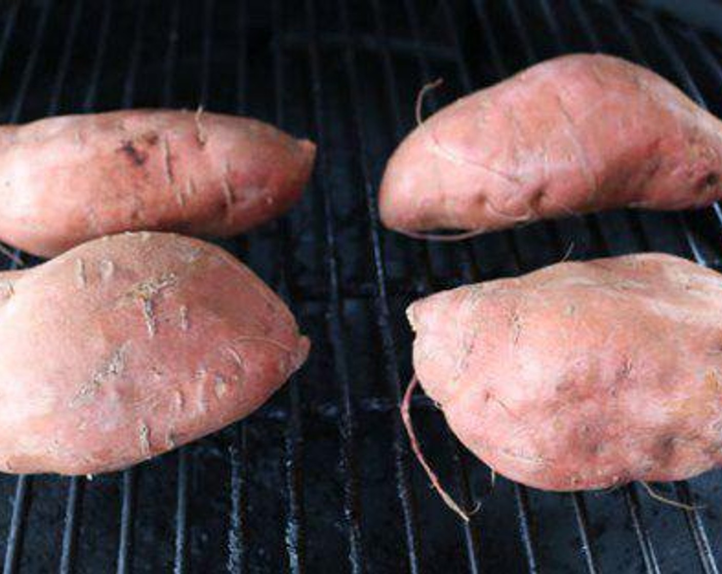step 2 Place Sweet Potatoes (4) on smoker and cook for 1:30 hours or until soft. Skewer should go into the potato with no resistance. Remove the sweet potatoes from the smoker and adjust vents so temperature drops to 350 degrees F (180 degrees C).