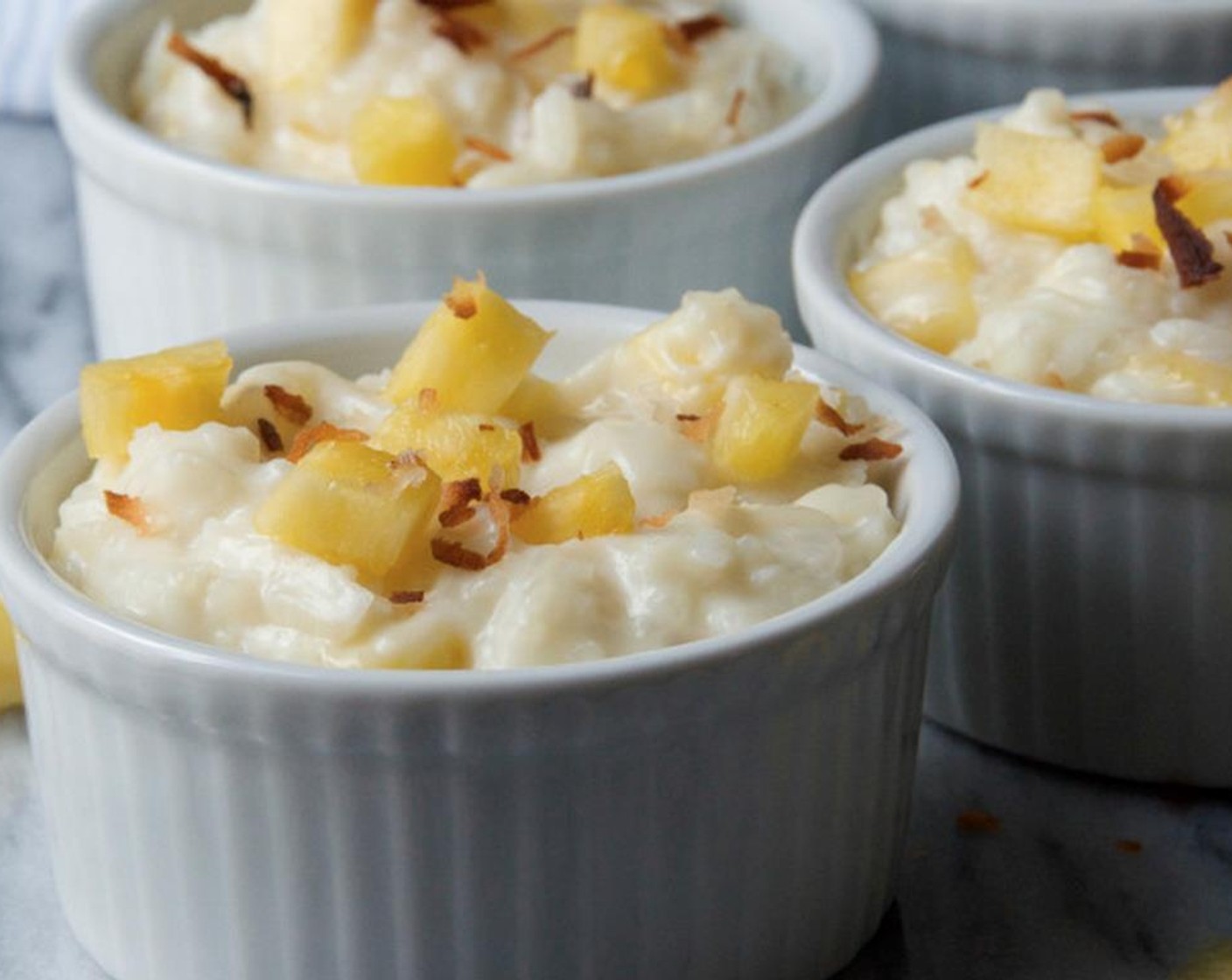 step 6 Top puddings with additional pineapple and toasted coconut. Serve.