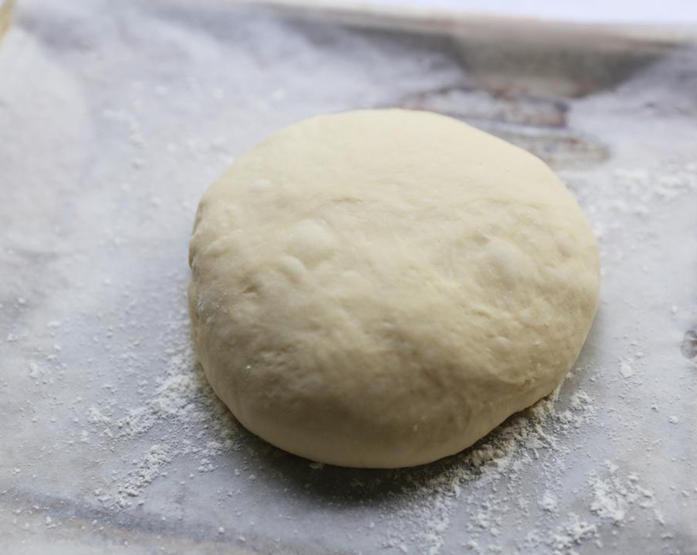 step 6 Knock the dough down gently and shape into a round ball. Place on a floured baking tray and allow to prove for another hour.