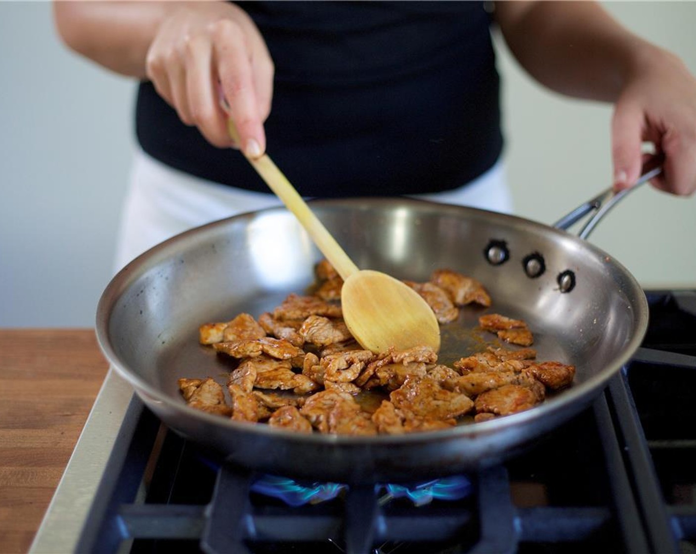 step 9 Add two teaspoons of oil to the pan. When hot, add the pork and cook for one to two minutes on both sides until cooked through.