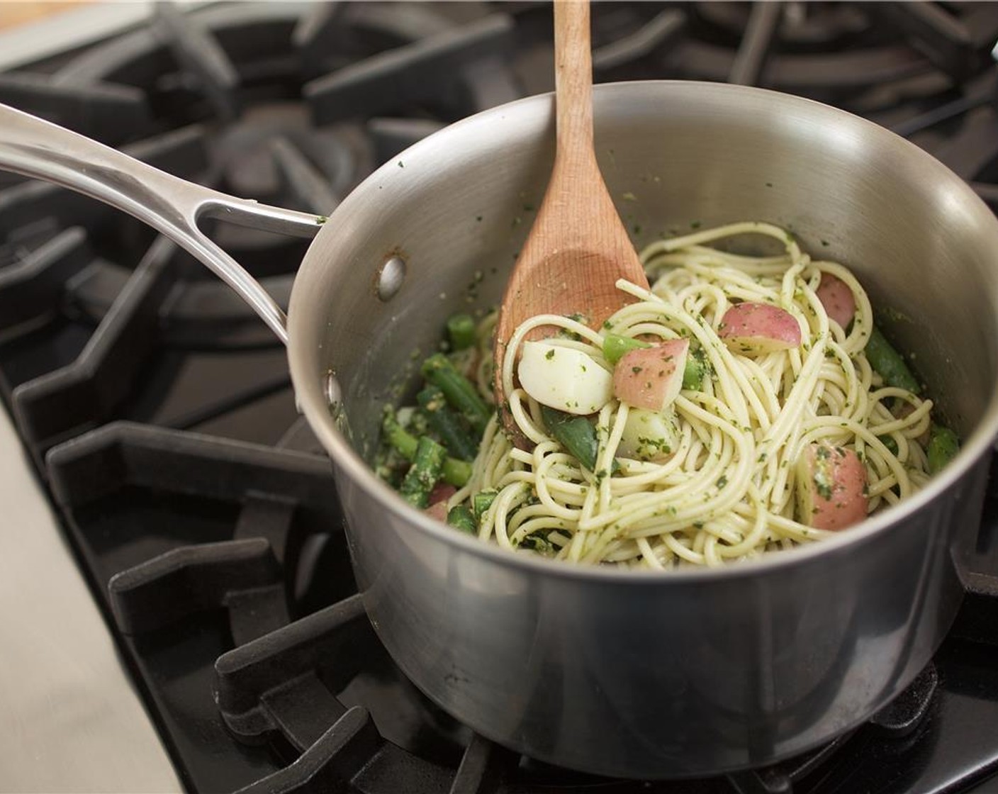 step 9 Add the pesto to the pot with the pasta and vegetables and toss until well incorporated. Add the lemon juice and half of the zest. Toss.