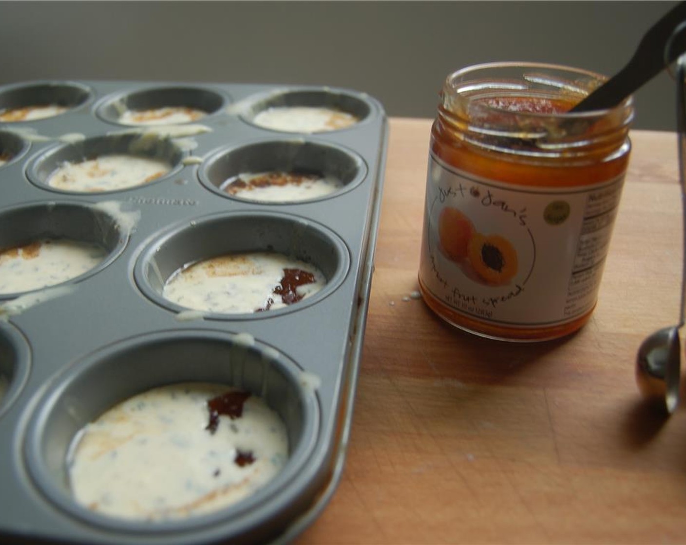step 5 Stir the batter and divide between muffin cups. You may add a 1/2 tsp of Just Jan’s® Apricot Fruit Spread (to taste) to the batter in each cup.