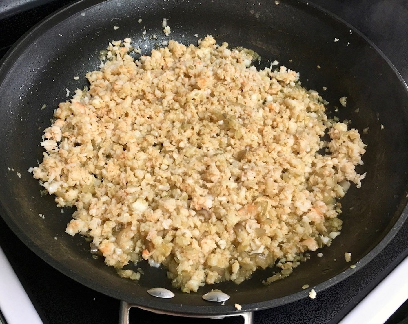 step 9 Return chopped shrimp to the skillet, and heat up over medium heat. Add Kosher Salt (1 tsp), Freshly Ground Black Pepper (to taste), and Cayenne Pepper (1 dash), and stir.