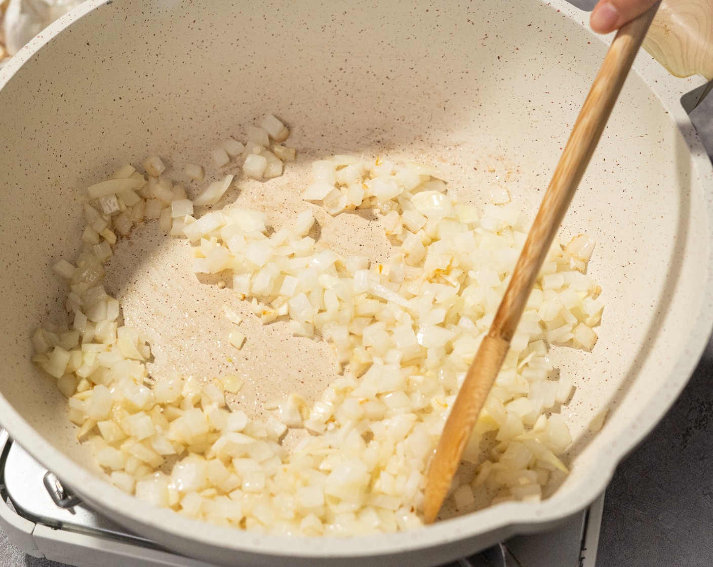 step 3 While the potatoes are cooking, heat the Vegetable Oil (2 Tbsp) in the pan over medium heat. Add the Yellow Onion (1/2) and Garlic (3 cloves). Sauté for 2 minutes.