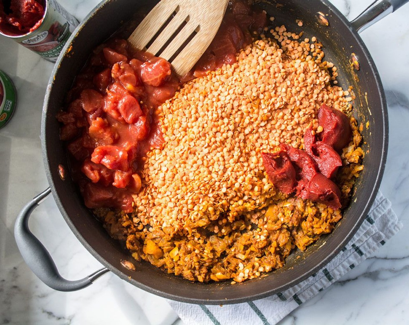 step 10 Add the Red Lentils (1 1/2 cups), Canned Diced Tomatoes (1 3/4 cups), Tomato Paste (1/3 cup), and Vegetable Broth (3 1/3 cups). Stir to combine and bring to a boil.