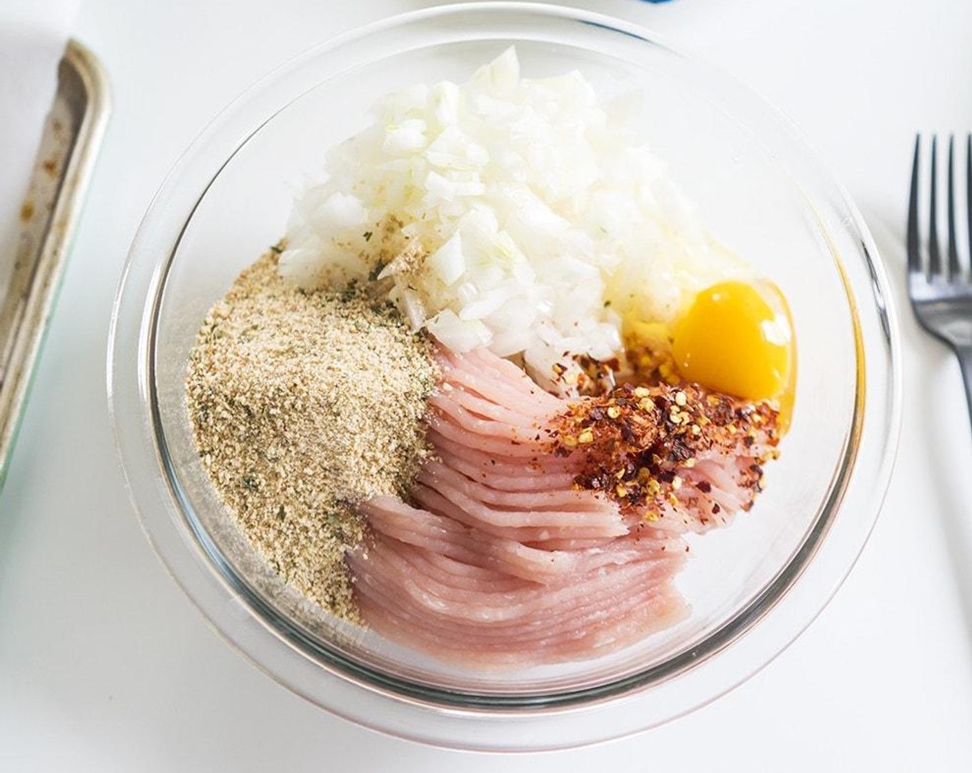 step 1 In a bowl, combine ground Lean Ground Turkey Breast (1 pckg), Yellow Onion (1), Garlic (2 cloves), Seasoned Panko Breadcrumbs (1/3 cup), Parmesan Cheese (1/4 cup), and Farmhouse Eggs® Large Brown Egg (1).
