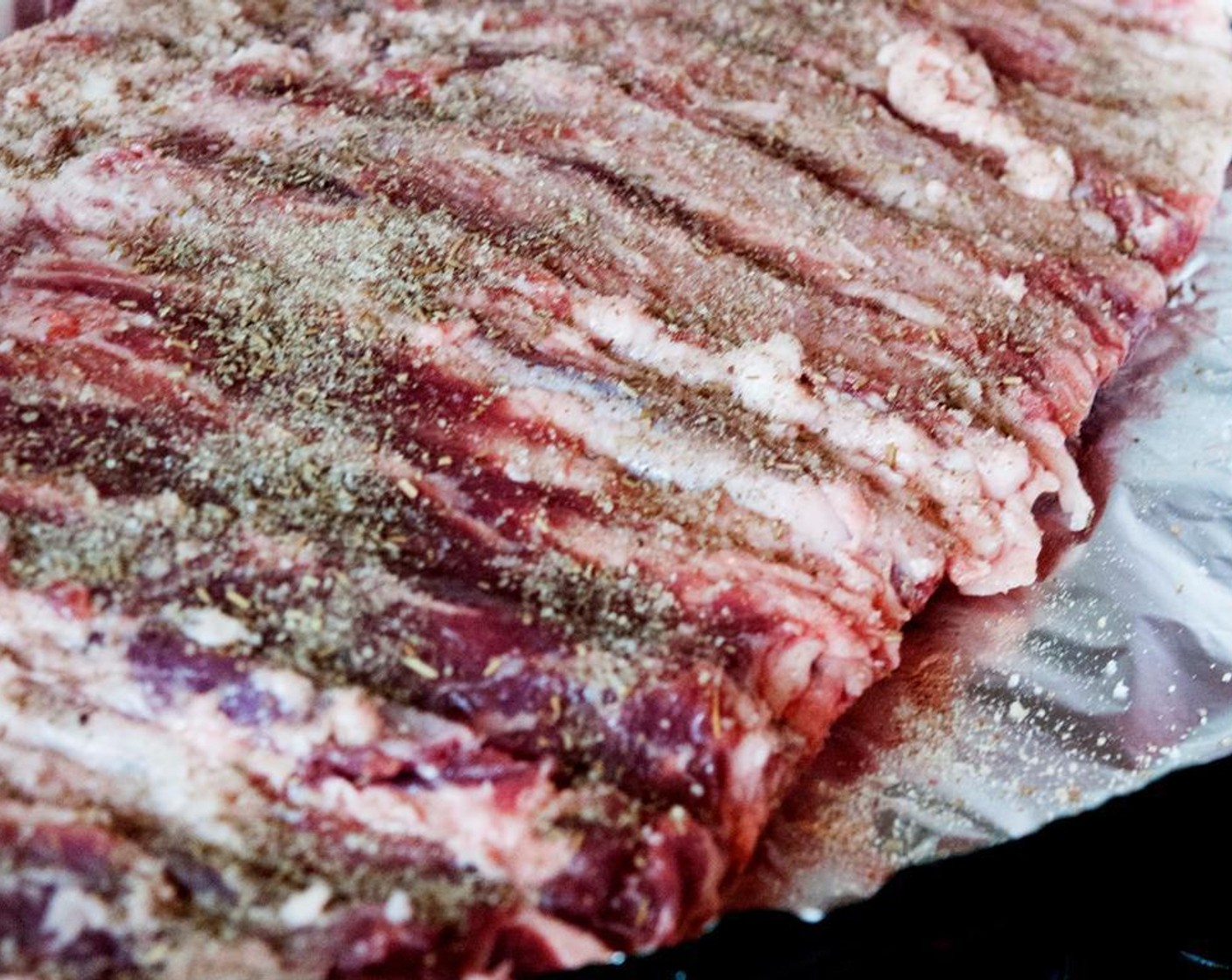 step 6 Place the ribs bone down on a baking tray and dress them with Salt (to taste) and Ground Black Pepper (to taste).