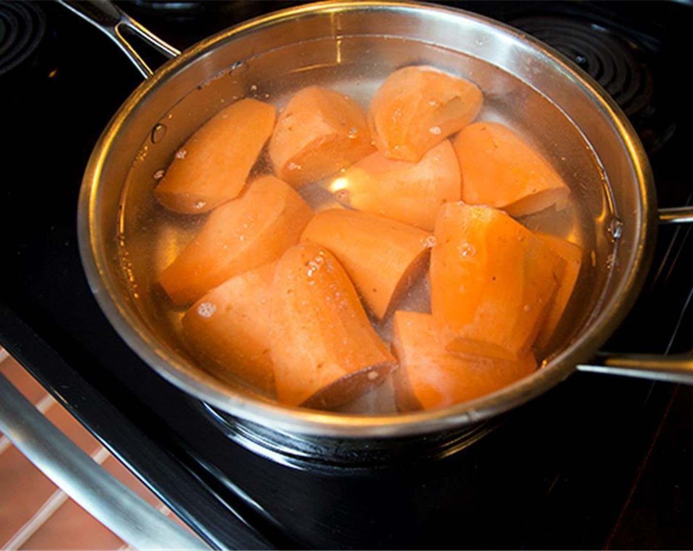 step 2 Place peeled and quartered Sweet Potatoes (3) in a large saucepan with enough water to cover. Bring to a boil and cook 25 minutes, or until tender but firm.