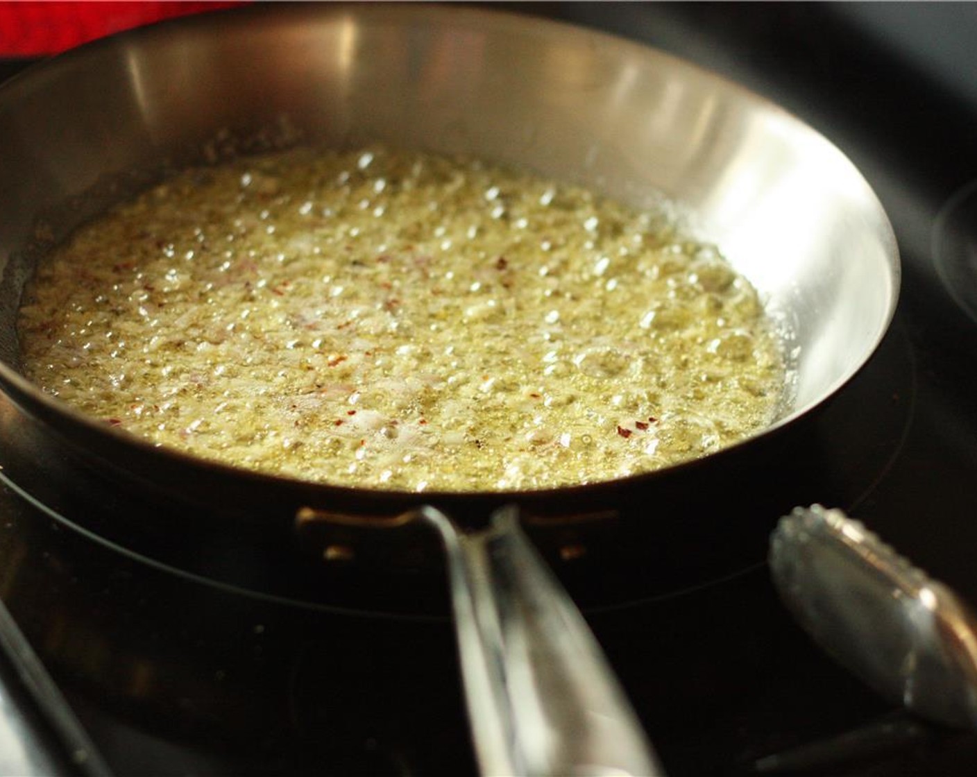 step 3 Once the butter and olive oil have begun to bubble, add the Garlic (3 cloves), Shallot (1), and Crushed Red Pepper Flakes (1/4 tsp) and sauté for 1-2 minutes, stirring frequently so the garlic does not burn.