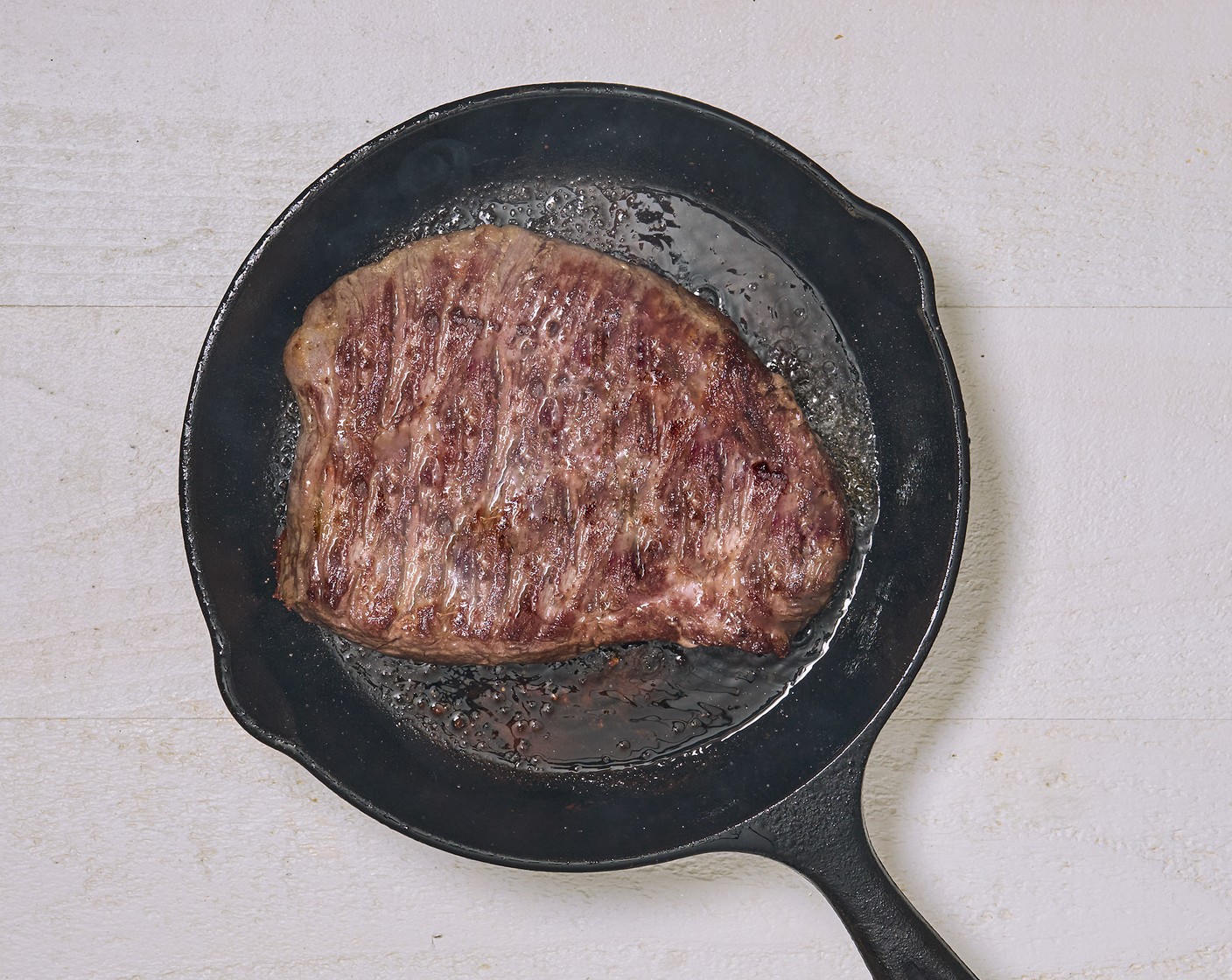 step 2 Heat a skillet and sear the steak on both sides for 3 minutes. Set the steak aside and let it rest while preparing the romaine.