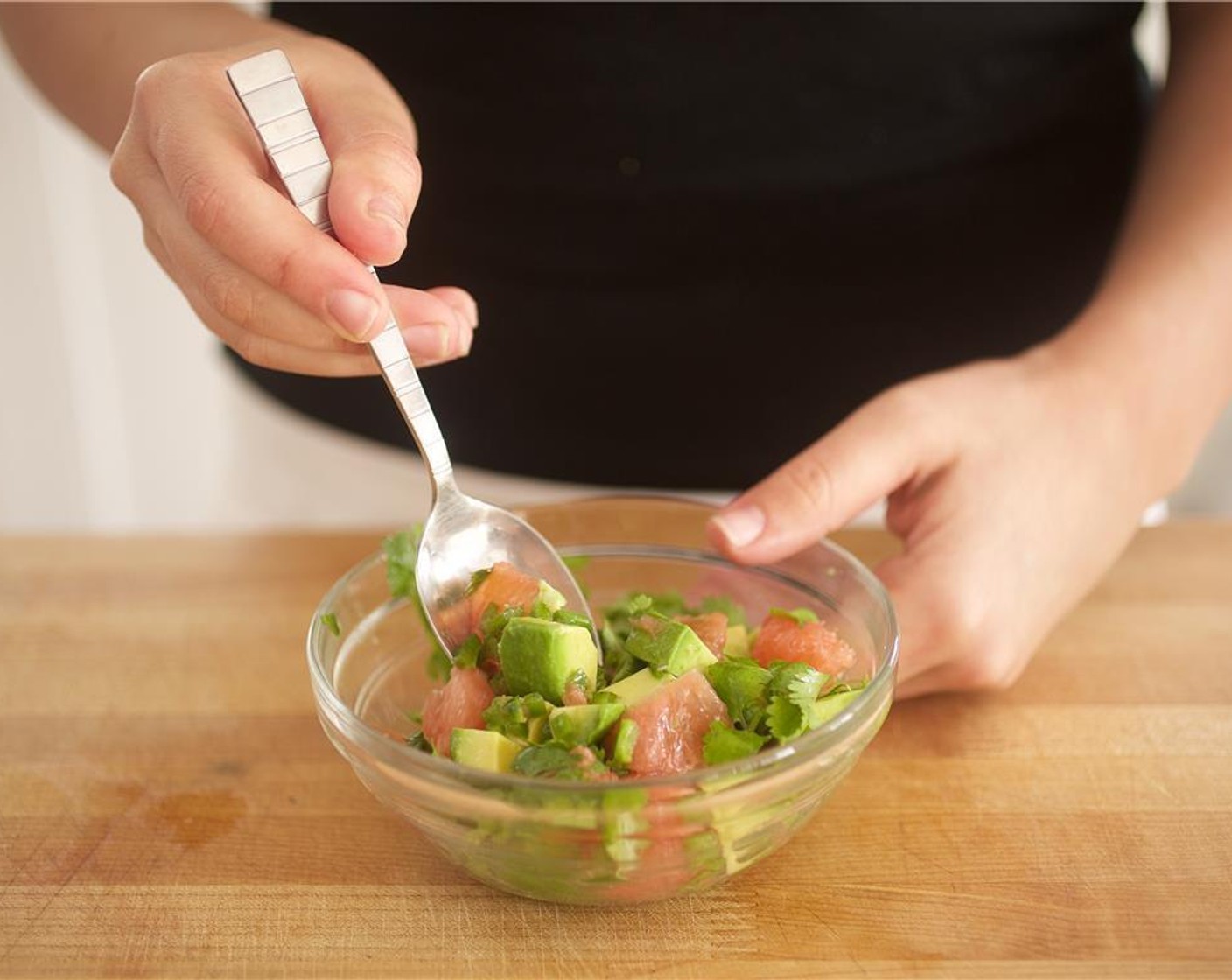 step 5 Cut Lime (1) in half. Slice one half into four wedges and set aside. Juice the other half of the lime and add to the bowl with the cilantro, jalapeno, grapefruit, and avocado. Add Salt (1/4 tsp) and gently stir to combine.