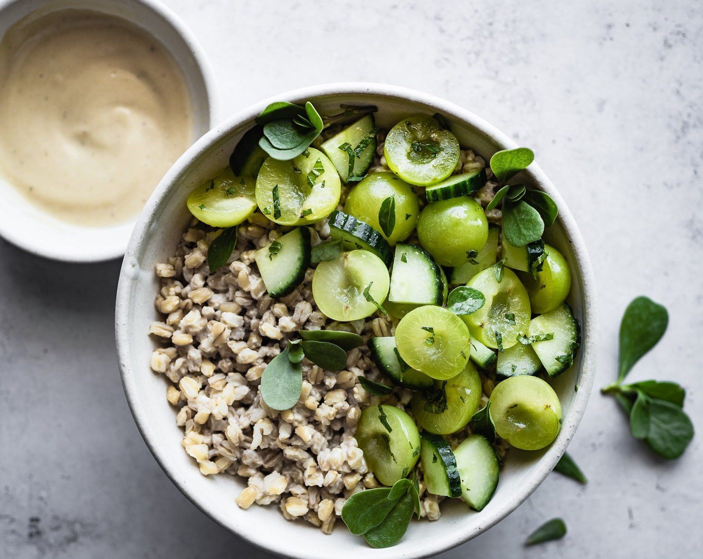 step 5 To serve, fill bowls with prepared wheat berries, top with marinated plum, cucumber salad, and garnish with Purslane (to taste) or other seasonal green. Add more dressing over the top as desired.