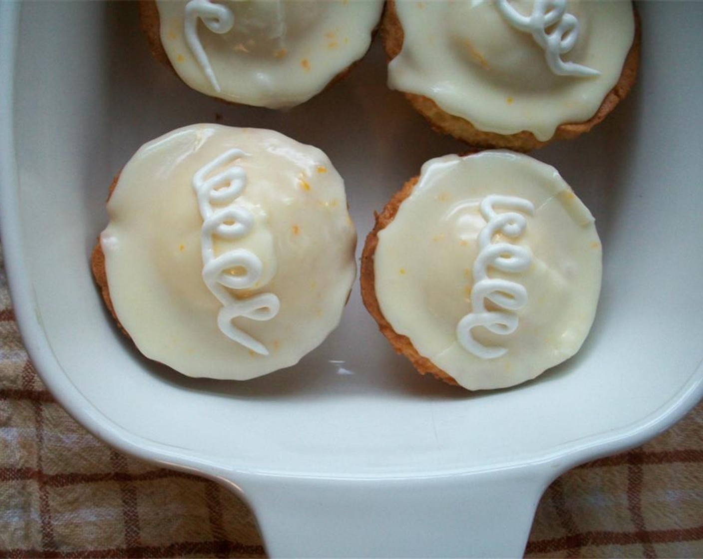 step 8 The meringue powder hardens the glaze slightly. Dip filled cupcake tops into the glaze. Switch piping bag tip to make a squiggly line with remaining frosting (optional). Enjoy!