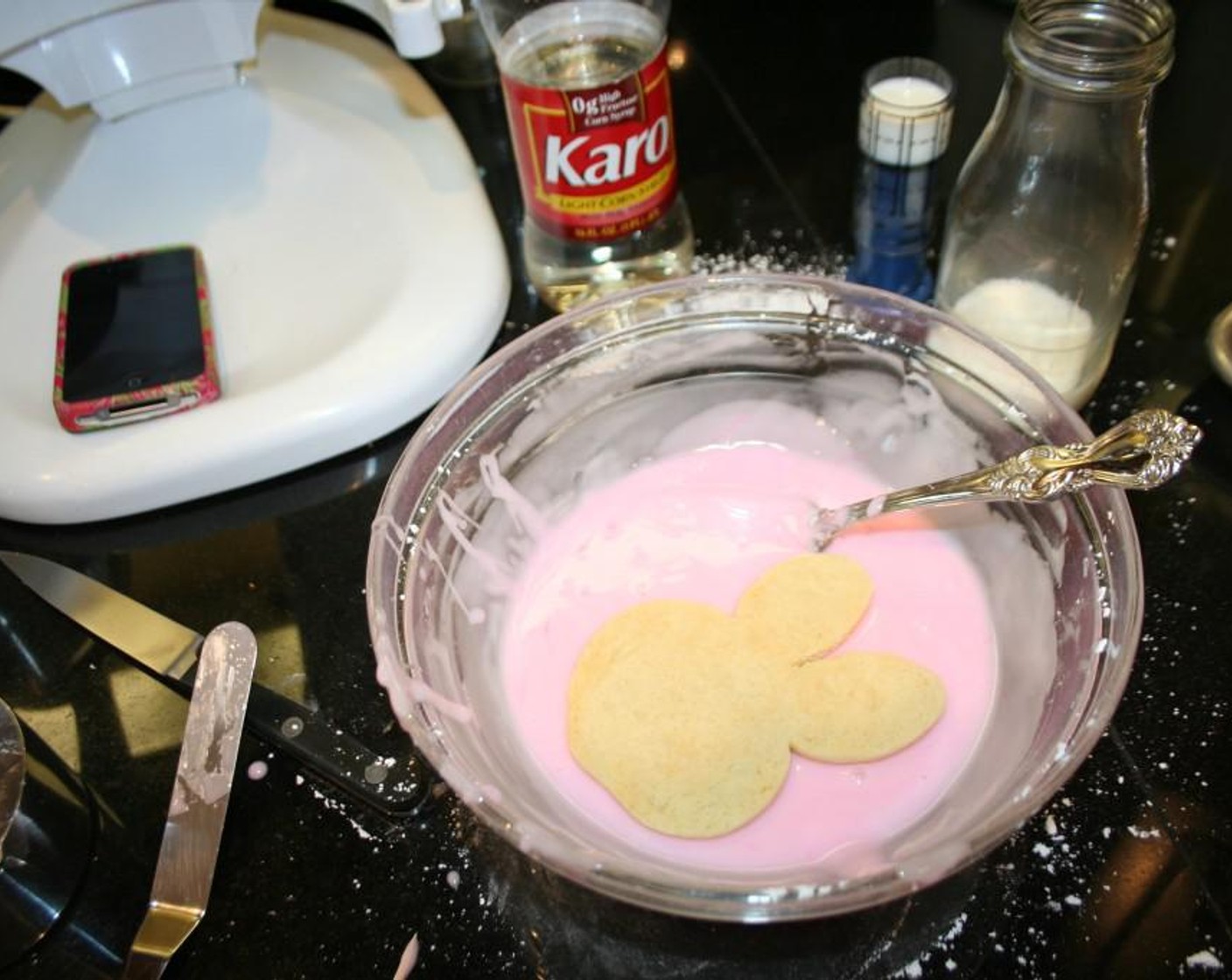 step 5 Mix Powdered Confectioners Sugar (2 1/4 cups), Light Corn Syrup (2 Tbsp), Whole Milk (3 Tbsp), Food Coloring (to taste) in a large flat bowl mix until all the lumps are gone and well mixed. Let this sit a while to let the bubbles work their way to the top otherwise you tend to get lots of bubbles in your icing later for 10 minutes.