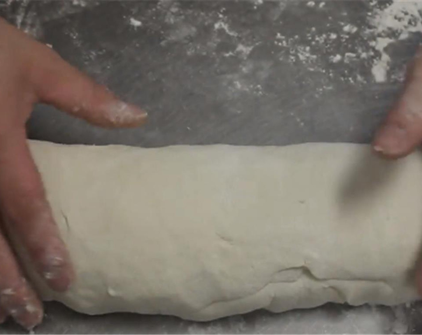 step 6 After resting begin to roll the dough out, forming a log shape.