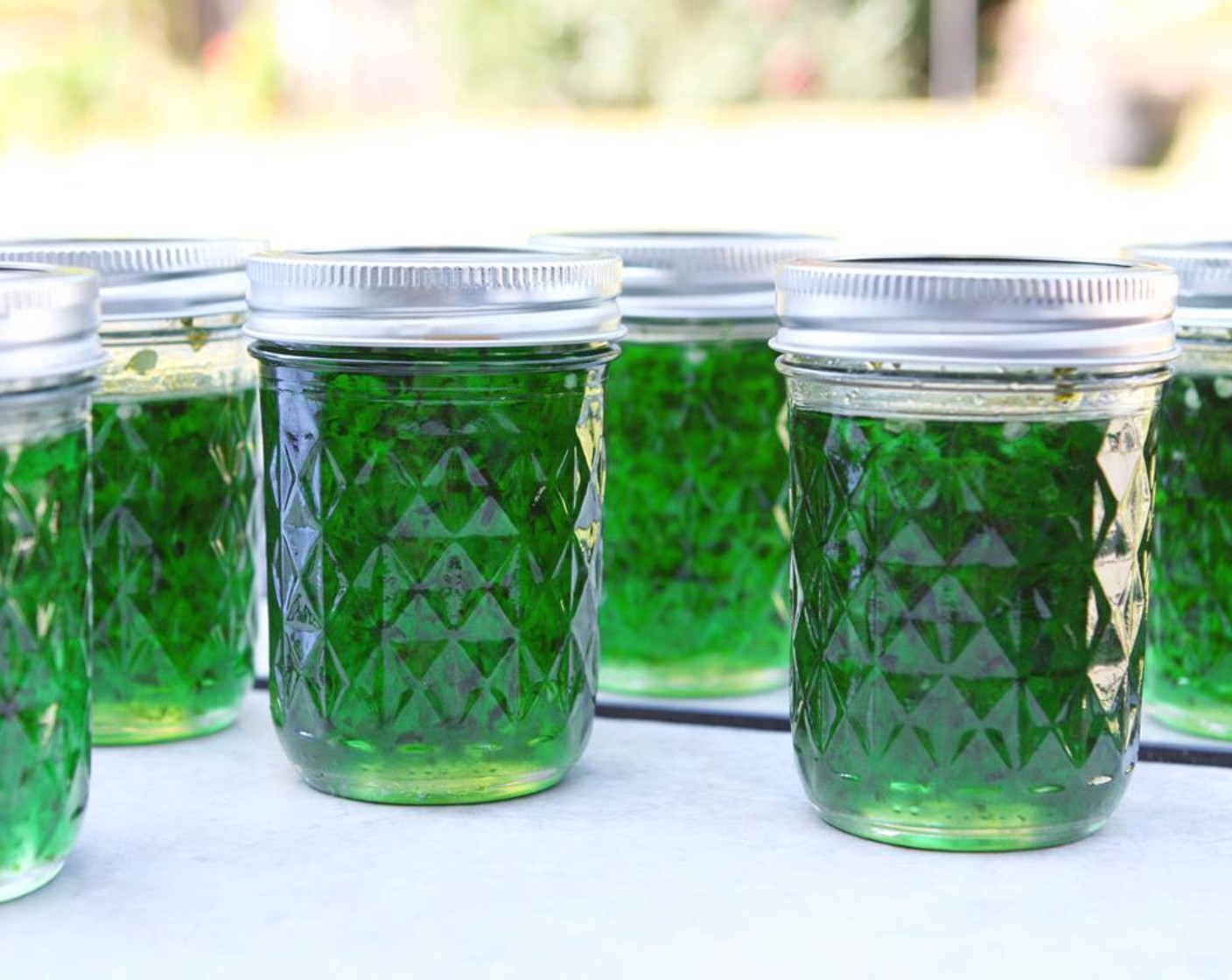 step 4 Pour the jelly, while hot, into sterilized, hot half-pint mason jars. Seal tightly with hot lids and set in a cool place. The lids will pop as they seal. Store at room temperature or in the refrigerator.