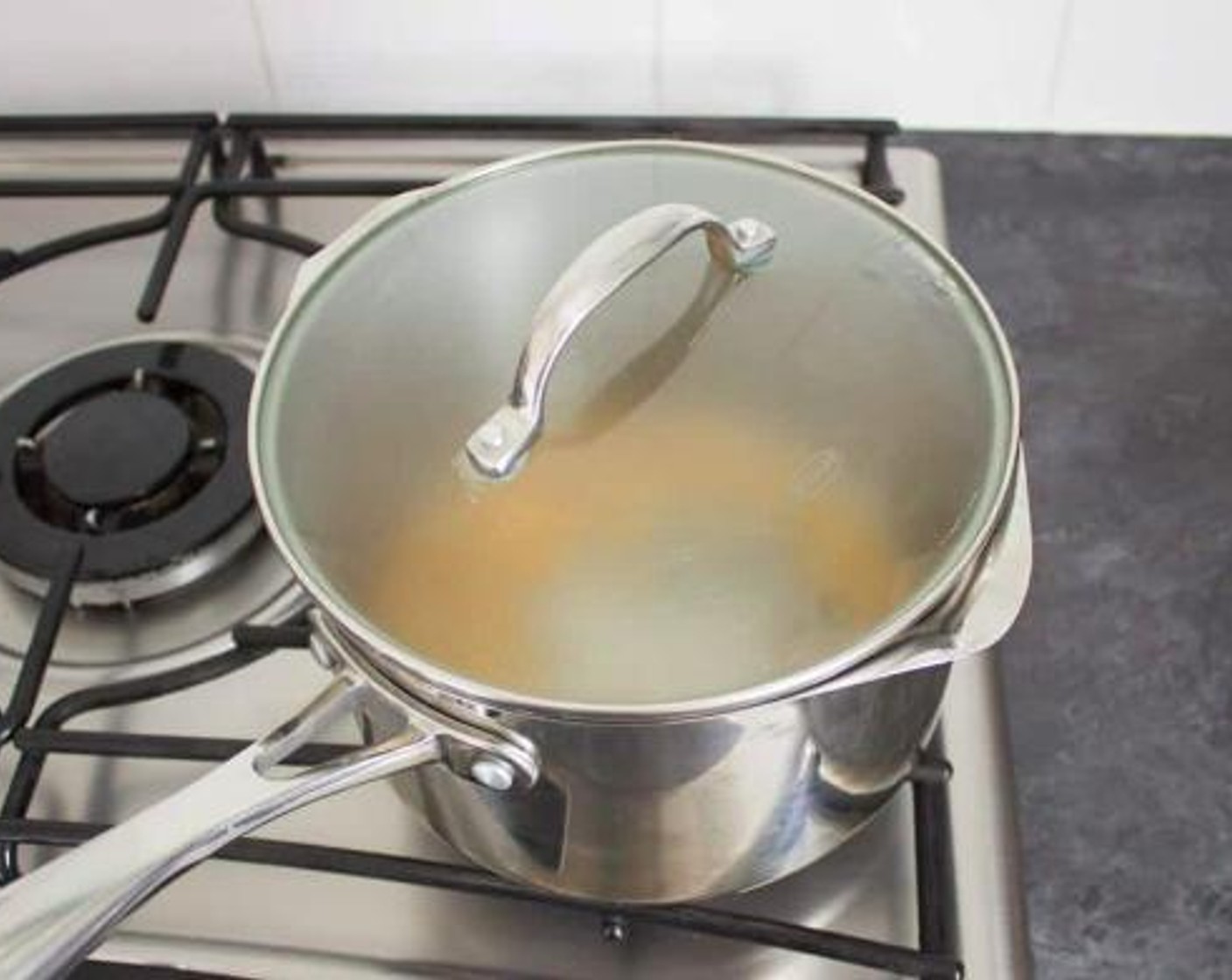 step 1 Heat the Rice Bran Oil (1 Tbsp) in the saucepan over a medium high heat. To test the temperature, throw a kernel in. When it pops, it’s hot enough! When it is, add all the Popcorn Kernels (1 cup), put the lid on and shake a little. Turn the heat down to medium low once they start popping.