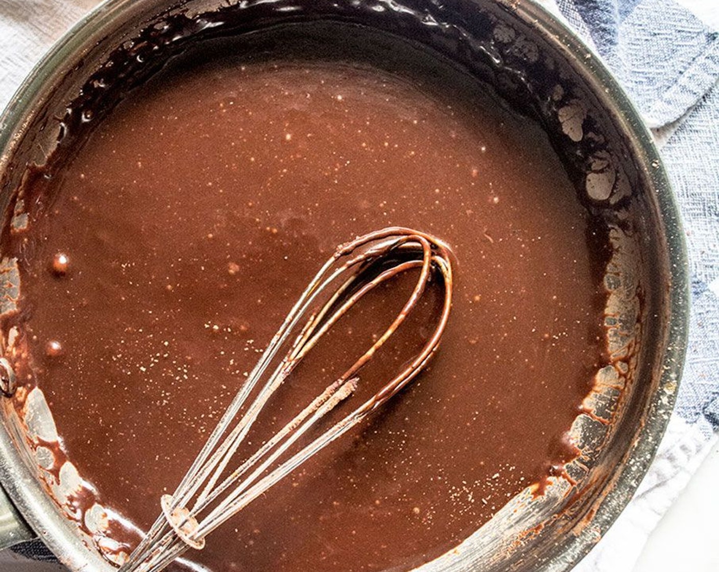 step 4 Remove from heat and slowly stir in Cacao Powder (1/3 cup) along with Vanilla Extract (1/2 tsp) and Sea Salt (1/4 tsp). Whisk until combined.